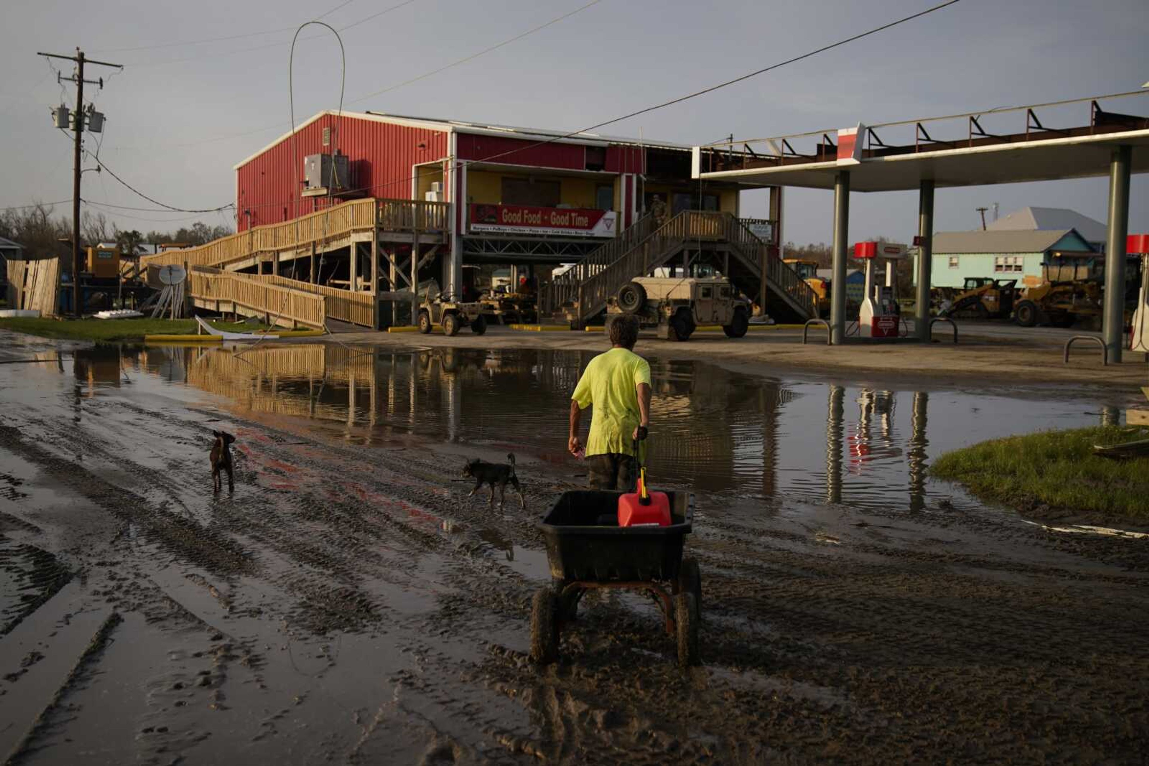 A man goes for gas at a hurricane-damaged gas station in the aftermath of Ida on Monday in Grand Isle, Louisiana.