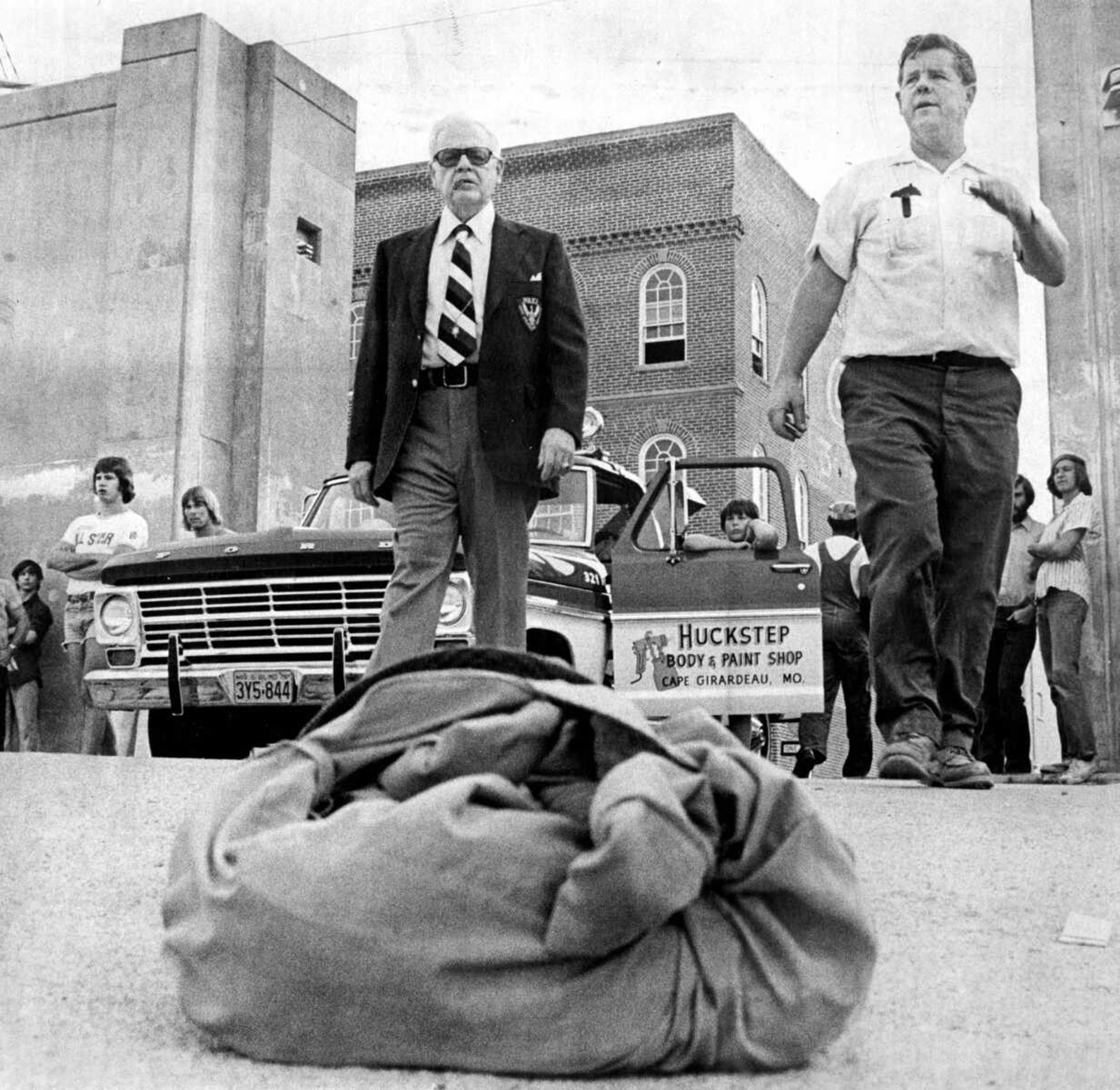 Police Chief Henry H. Gerecke, left, and Gene Huckstep, operator of a volunteer rescue service, rush to the Mississippi River at the Water-Themis floodgate as dragging operations begin late Thursday, June 27, 1975, for Gordon Y. Weakly, 53 years old. The Cape Girardeau man disappeared as he was swimming in the river.