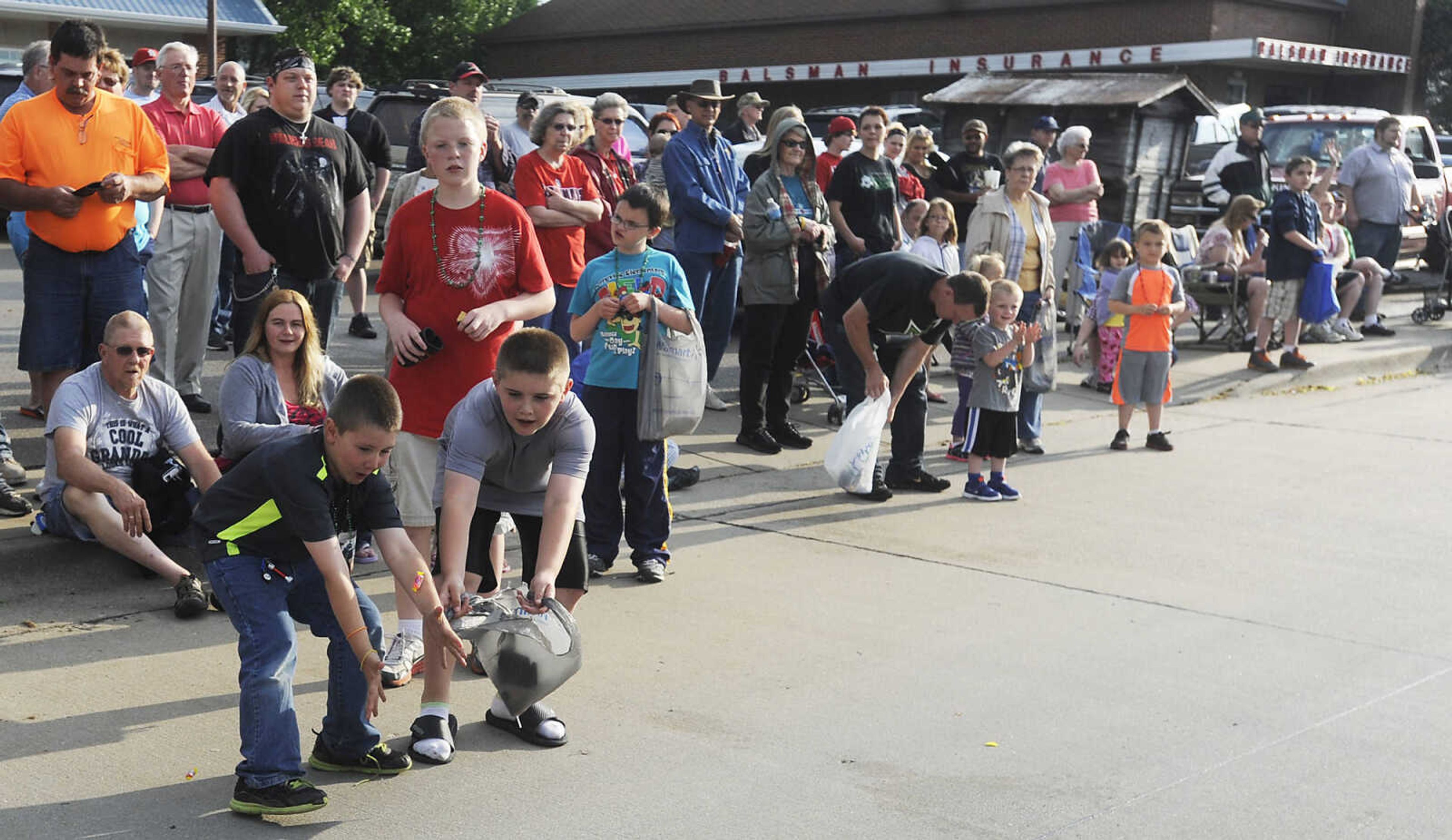 Children scramble for candy during the Perryville Mayfest Parade Friday, May 10, in Perryville, Mo. This year's Mayfest theme is Peace, Love, Perryville Mayfest.