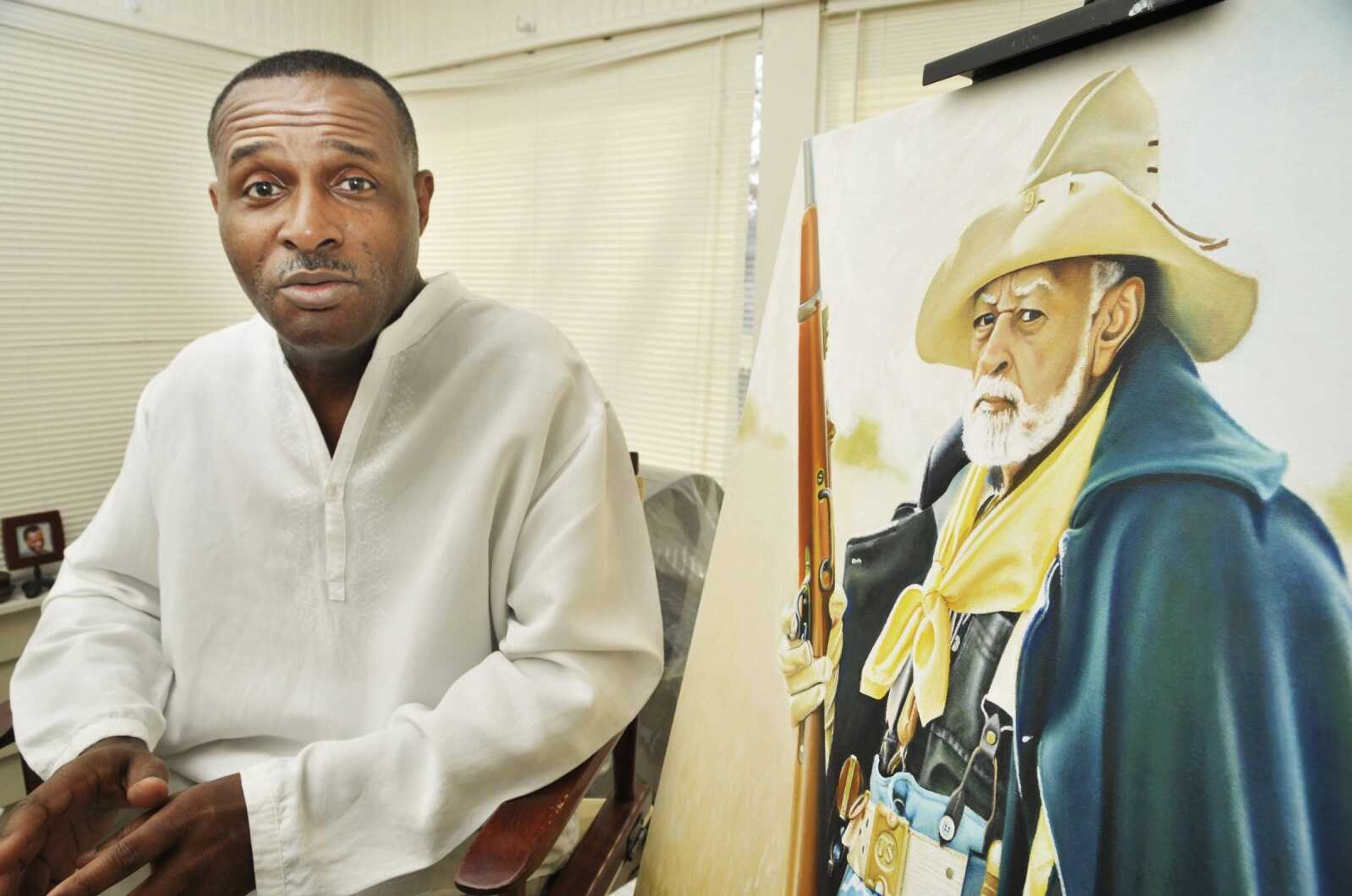 Artist Essex Garner sat down for an interview recently to talk about the painting of a Buffalo Soldier on which he is currently working in his Jefferson City, Mo., home studio. He is painting a series of Civil War portraits that will eventually be displayed in a case in Scruggs Student Center on the campus of Lincoln University. (AP Photo/Jefferson City News Tribune, Julie Smith)