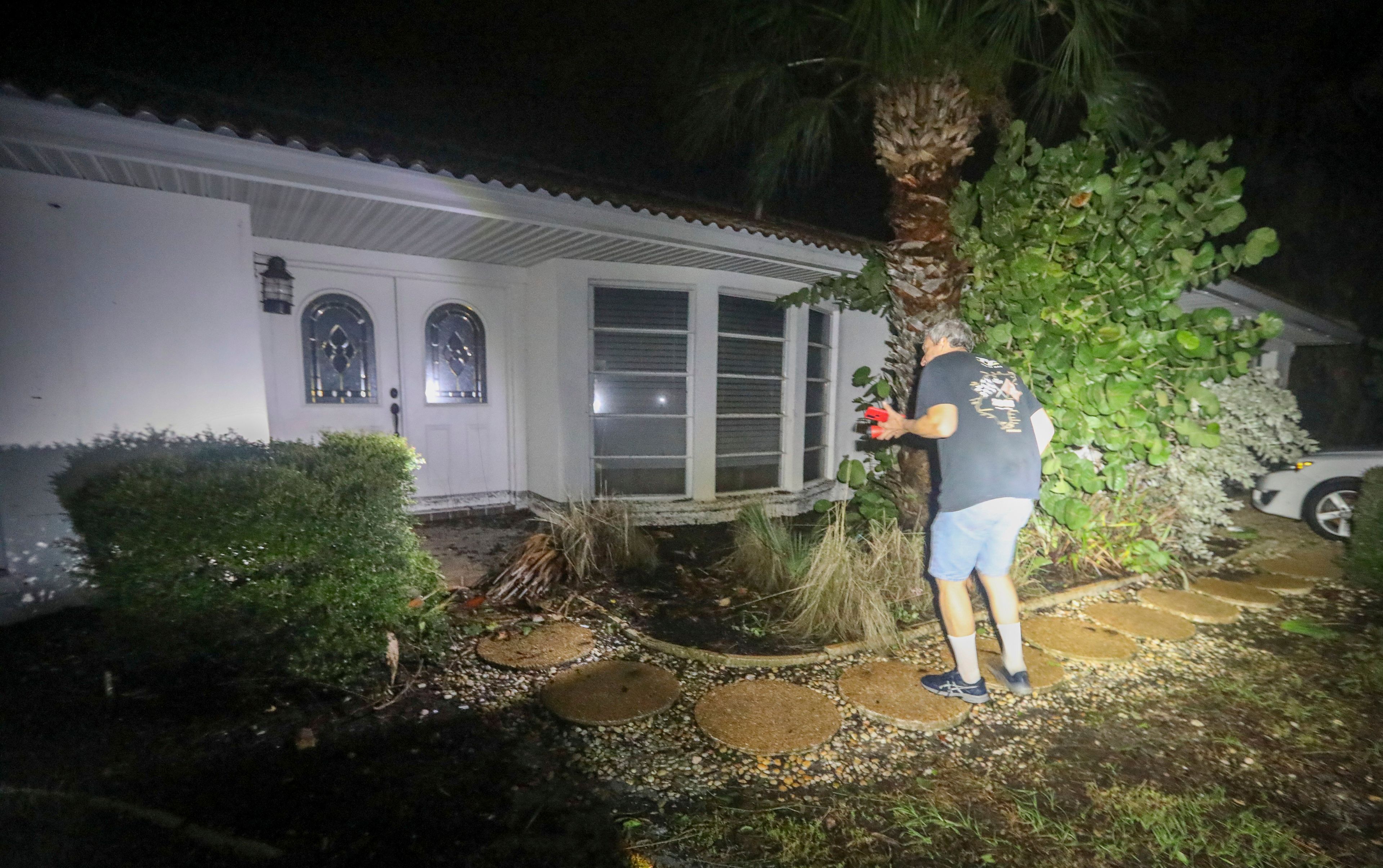 Doug Manning surveys damage to his Siesta Key, Fla., home after Hurricane Milton made landfall nearby Thursday, Oct. 10, 2024. (Chris Urso/Tampa Bay Times via AP)