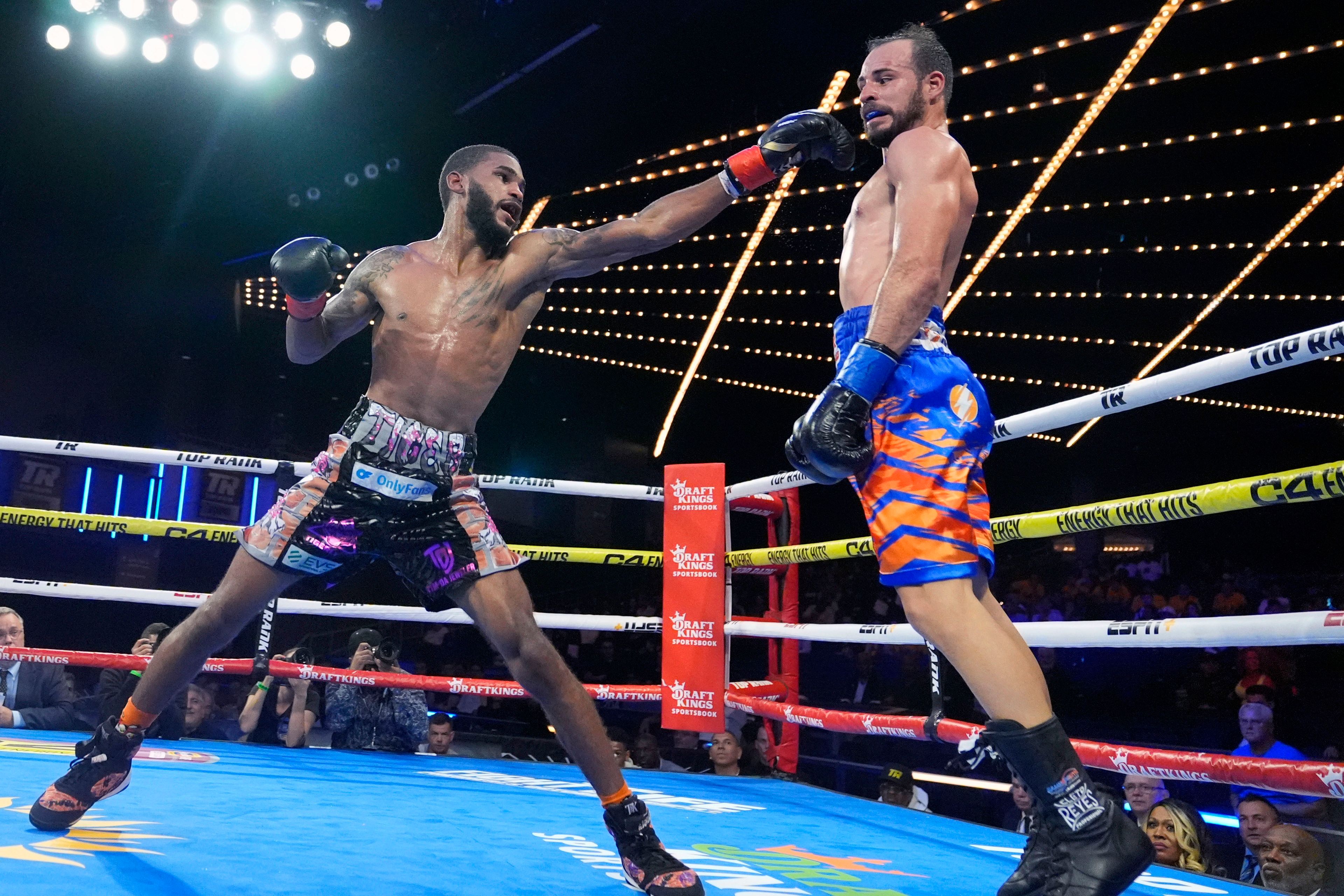 Delante Johnson, left, punches Puerto Rico's Yomar Alamo, right, during their welterweight boxing bout Friday, Sept. 27, 2024, in New York. Johnson won the fight. (AP Photo/Frank Franklin II)