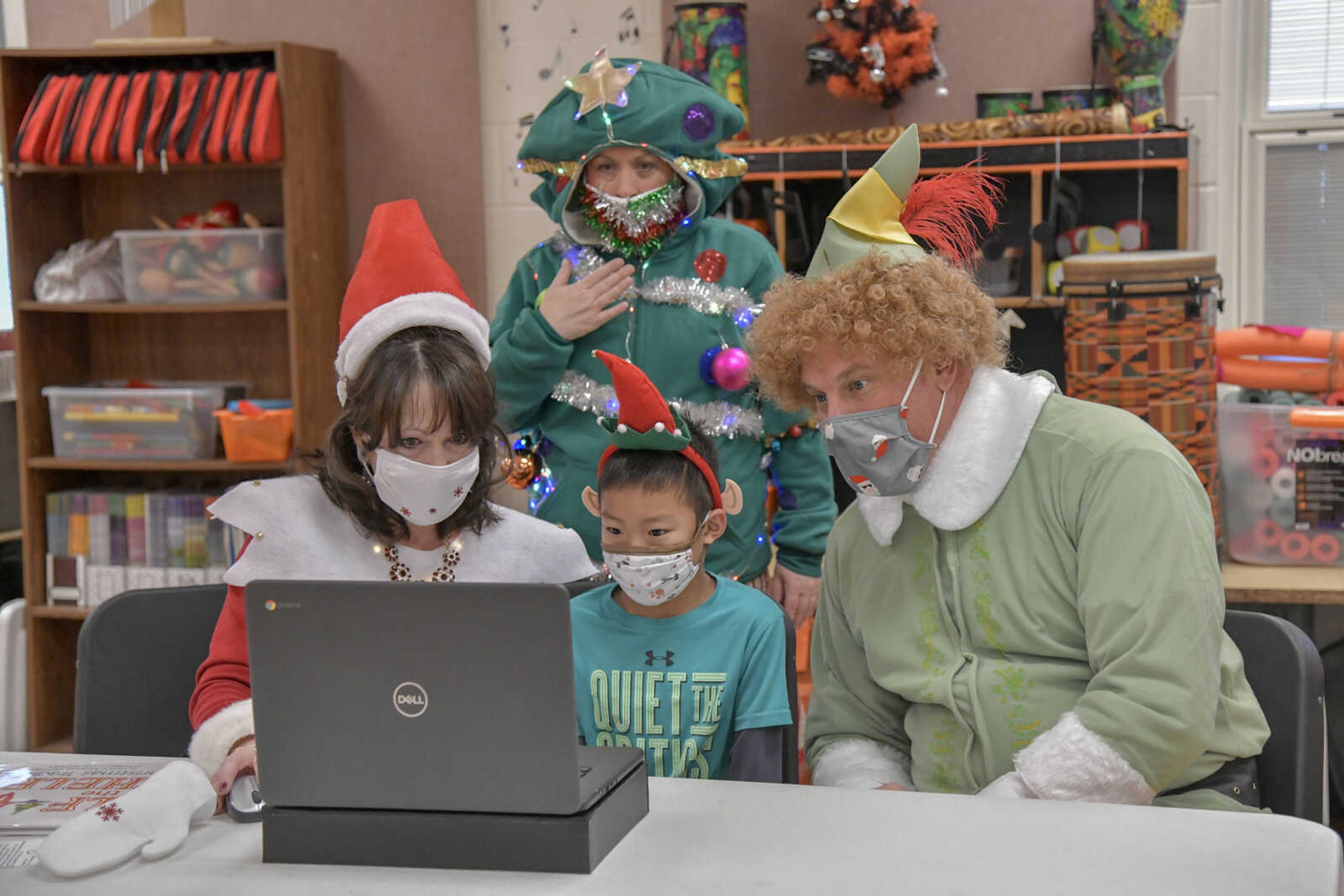 Principal Julia Unnerstall&nbsp;as Elf on the Shelf, third grade student Ben Cao, Superintendent Dr. Neil Glass as Buddy the Elf and Psychological Examiner Stephanie Craft as a Christmas tree speak on a zoom call for the morning meeting at Alma Schrader Elementary School in Cape Girardeau on Thursday, Dec. 17, 2020. The group encouraged students to do caring actions, such as helping others without expecting anything in return, as part of "Caring Thursday."