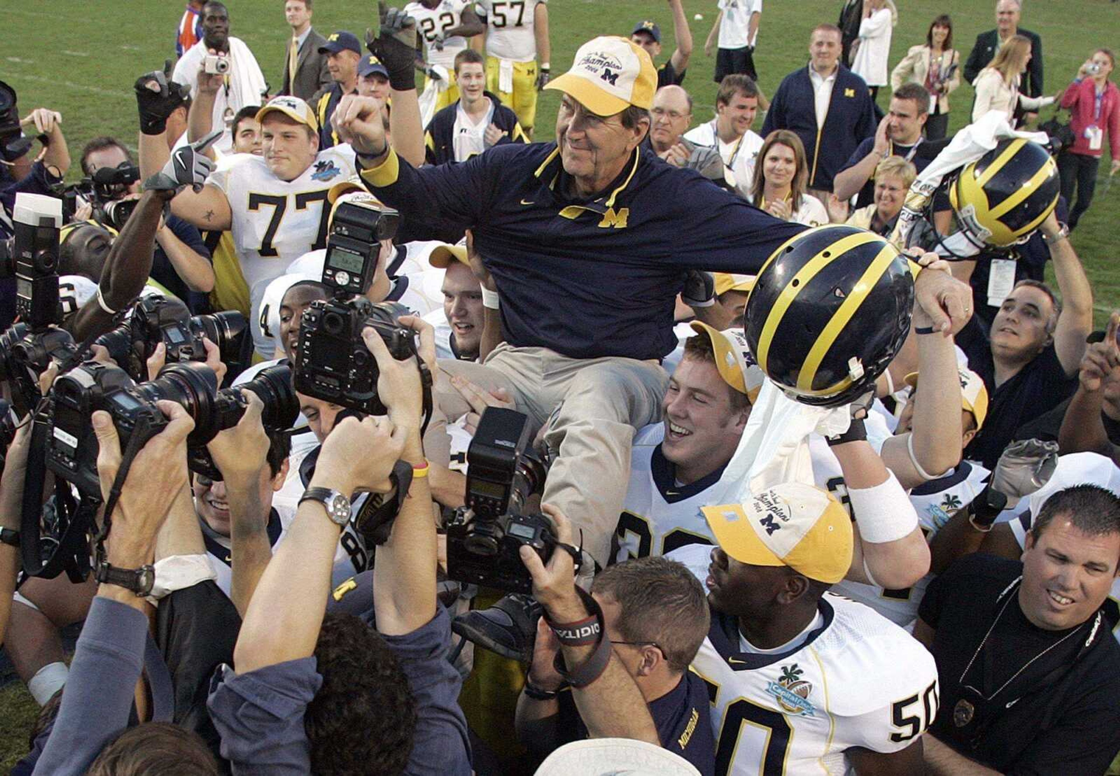 Michigan coach Lloyd Carr was carried off of the field Tuesday after the Wolverines' 41-35 victory over Florida in the Capital One Bowl in Orlando, Fla. (REINHOLD MATAY ~ Associated Press)