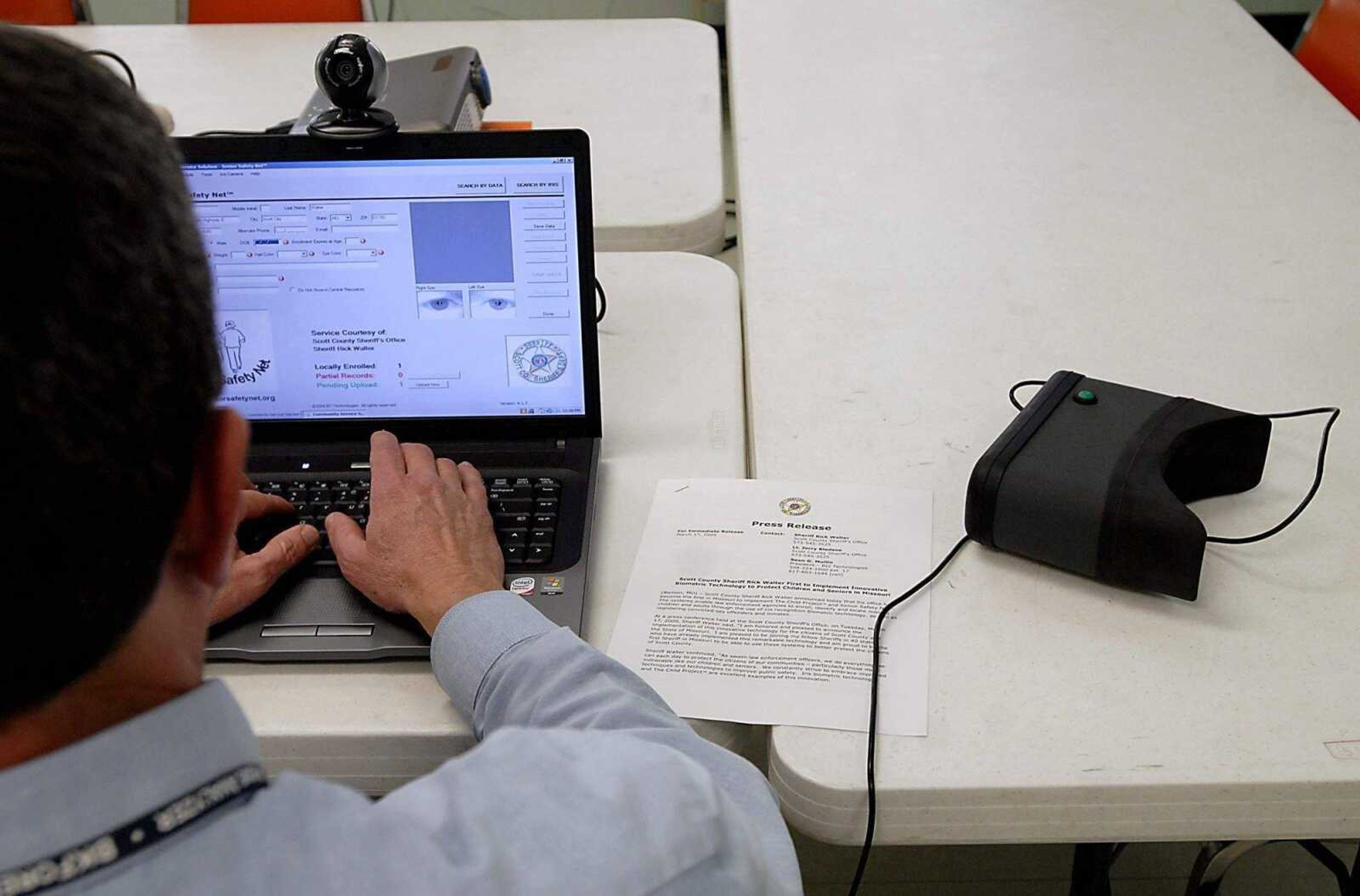 KIT DOYLE ~ kdoyle@semissourian.com<br>Lt. Jerry Bledsoe inputs information after scanning eyes with new biometric technology Wednesday in Benton. The Scott County Sheriff's Department is the first department in the state to employ the iris recognition software.