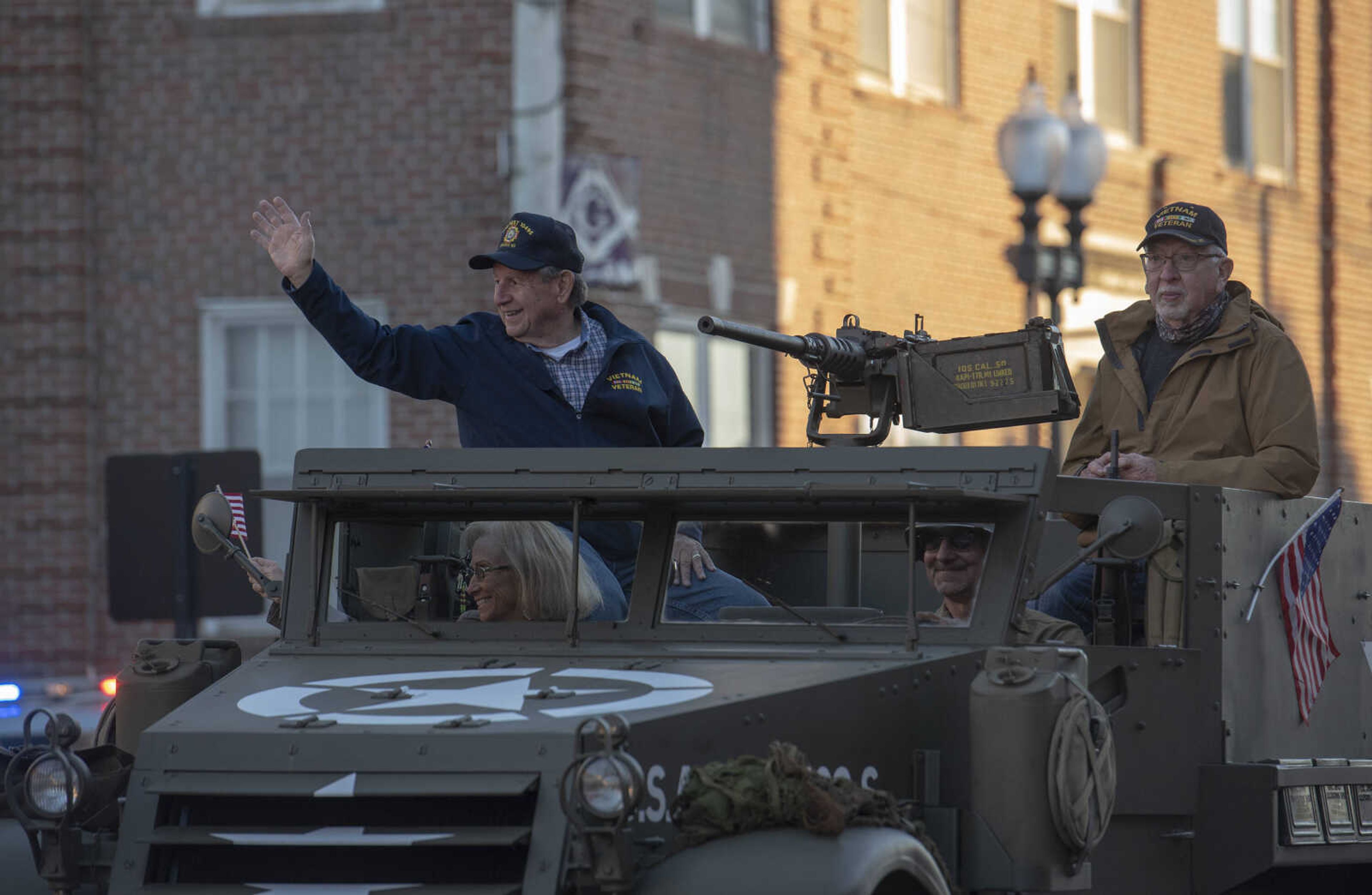 A veteran waves to the people on the side of the street during the Veteran's Day Parade in Jackson on Wednesday, Nov. 11, 2020.