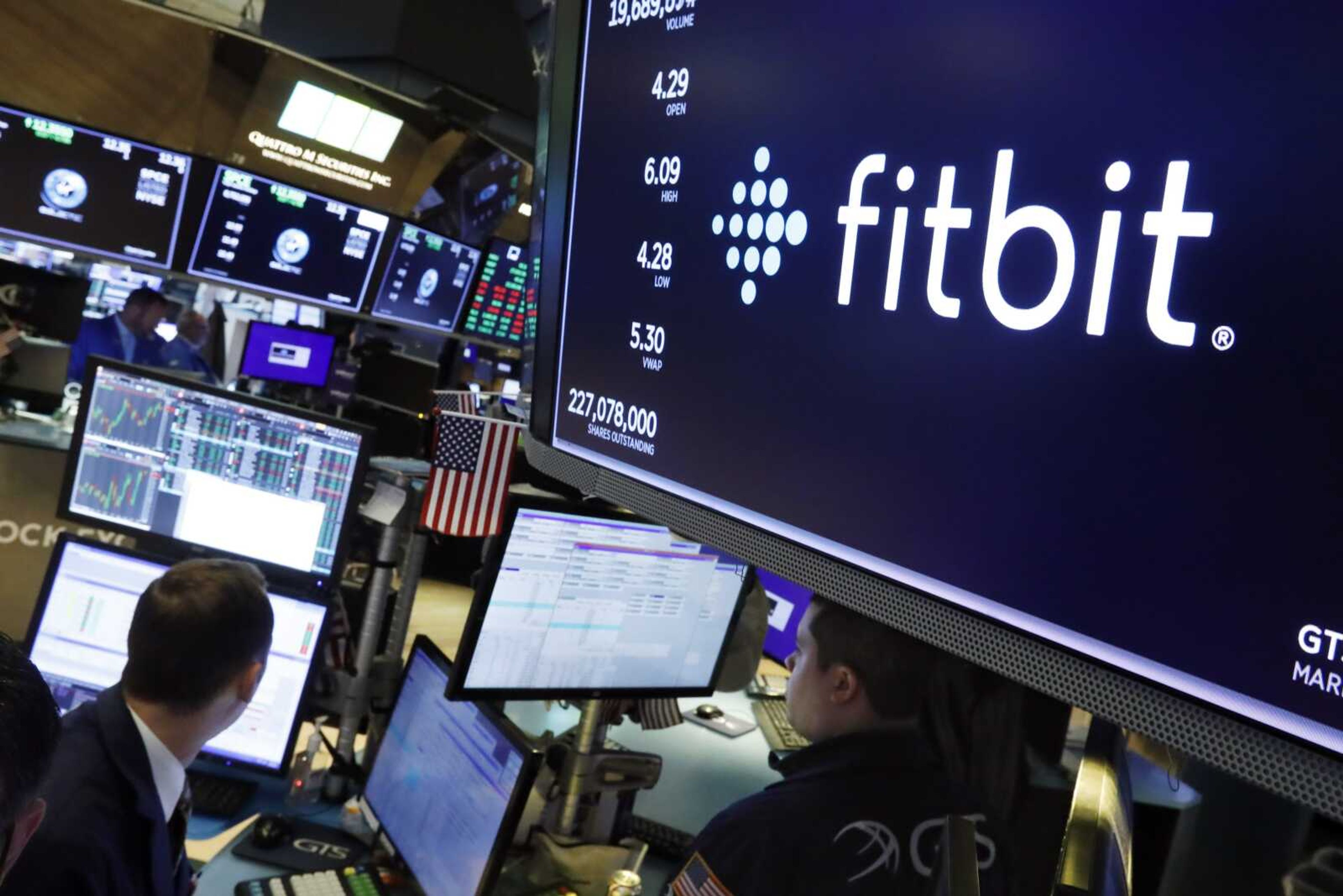 The logo for Fitbit appears above a trading post Oct. 28, 2019, on the floor of the New York Stock Exchange. Fitbit has recalled 1 million of its Ionic smartwatches Wednesday after dozens of users reported burn injuries because the battery overheated.