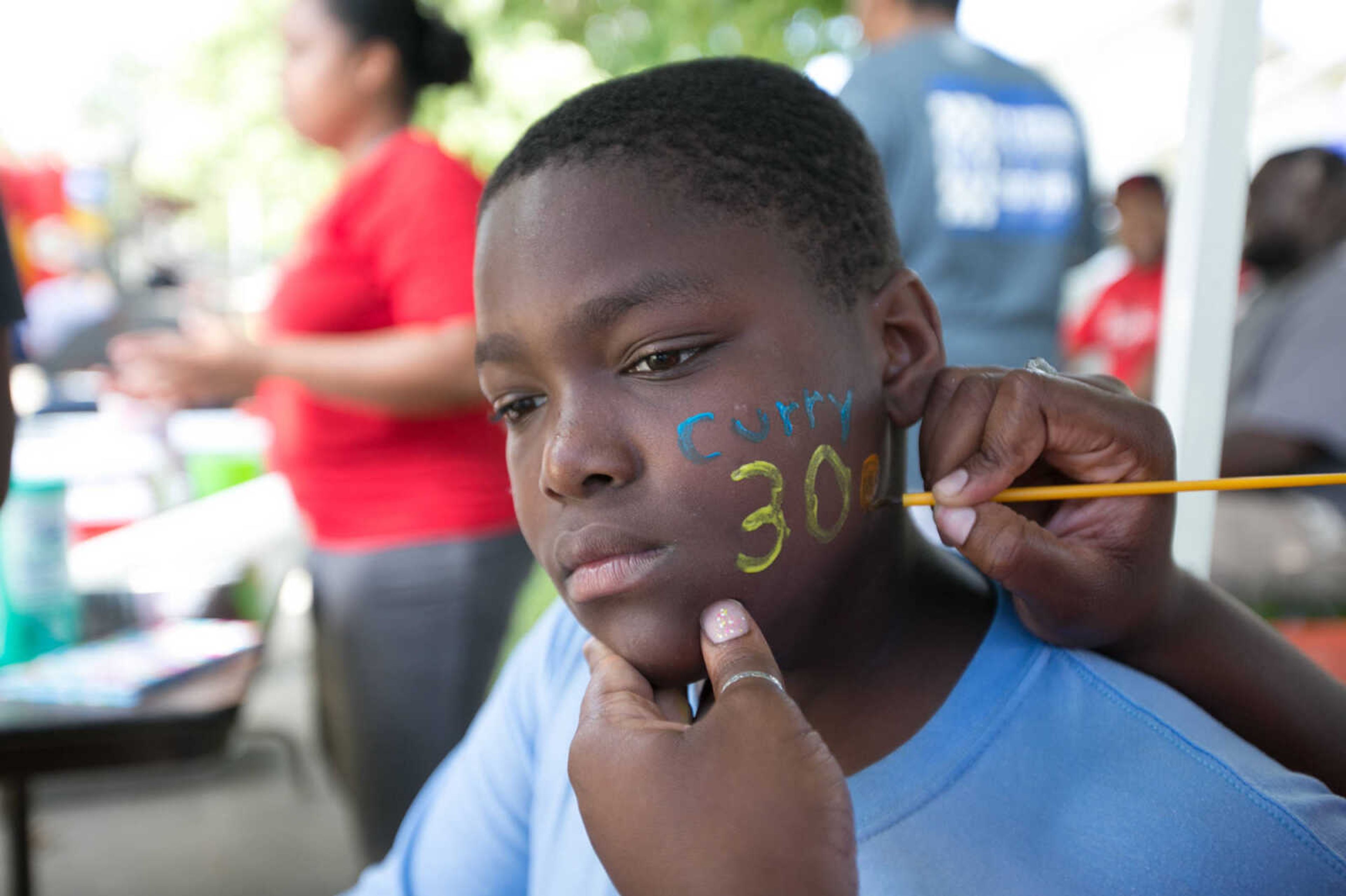 GLENN LANDBERG ~ glandberg@semissourian.com

Daniel Bird Jr. has the name of his favorite basketball player painted on his face during a block party in Cape Girardeau's ward 2 area, Saturday, June 20, 2015.