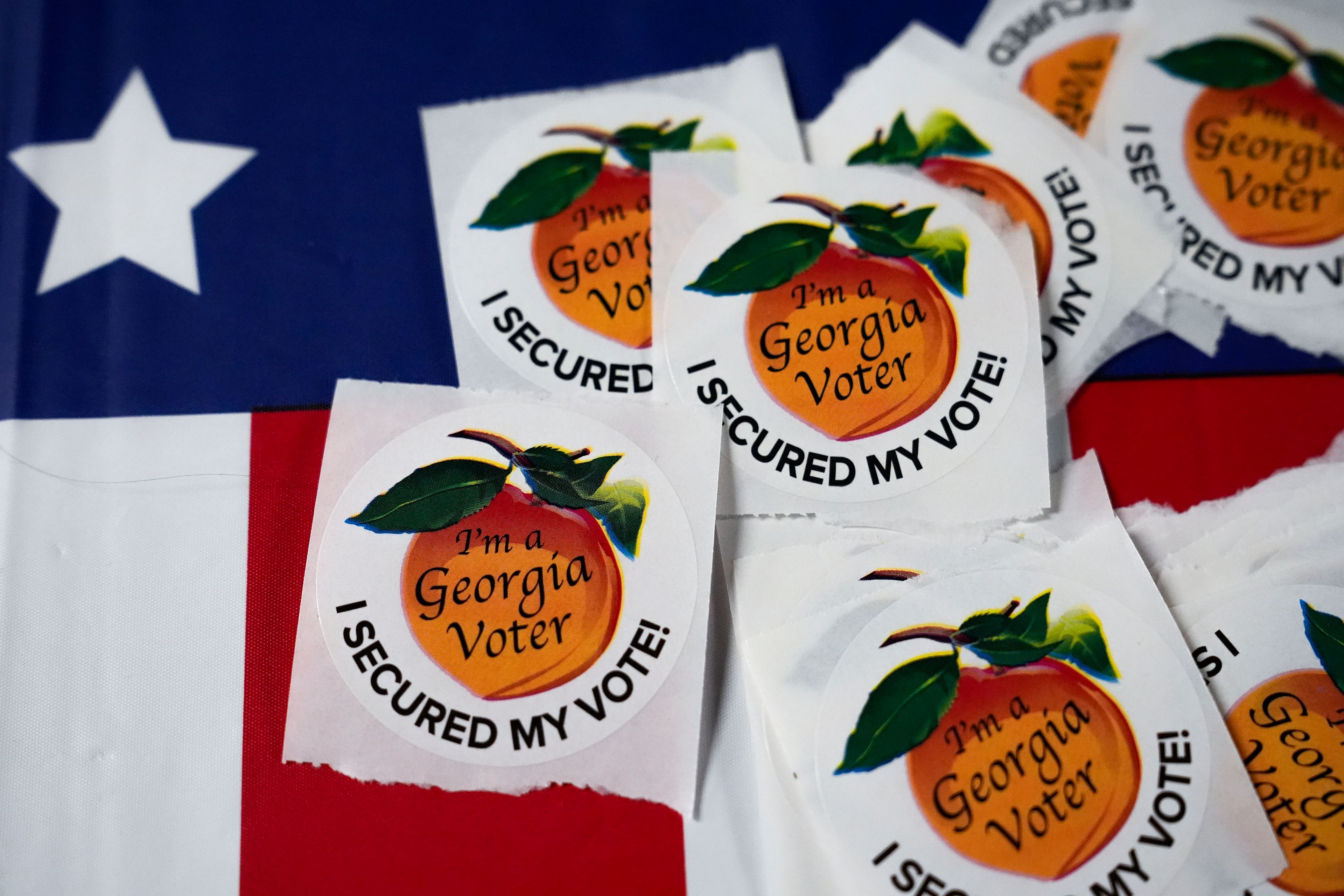 Stickers sit on a table inside a polling place, Tuesday, Nov. 5, 2024, in Atlanta. (AP Photo/Brynn Anderson)