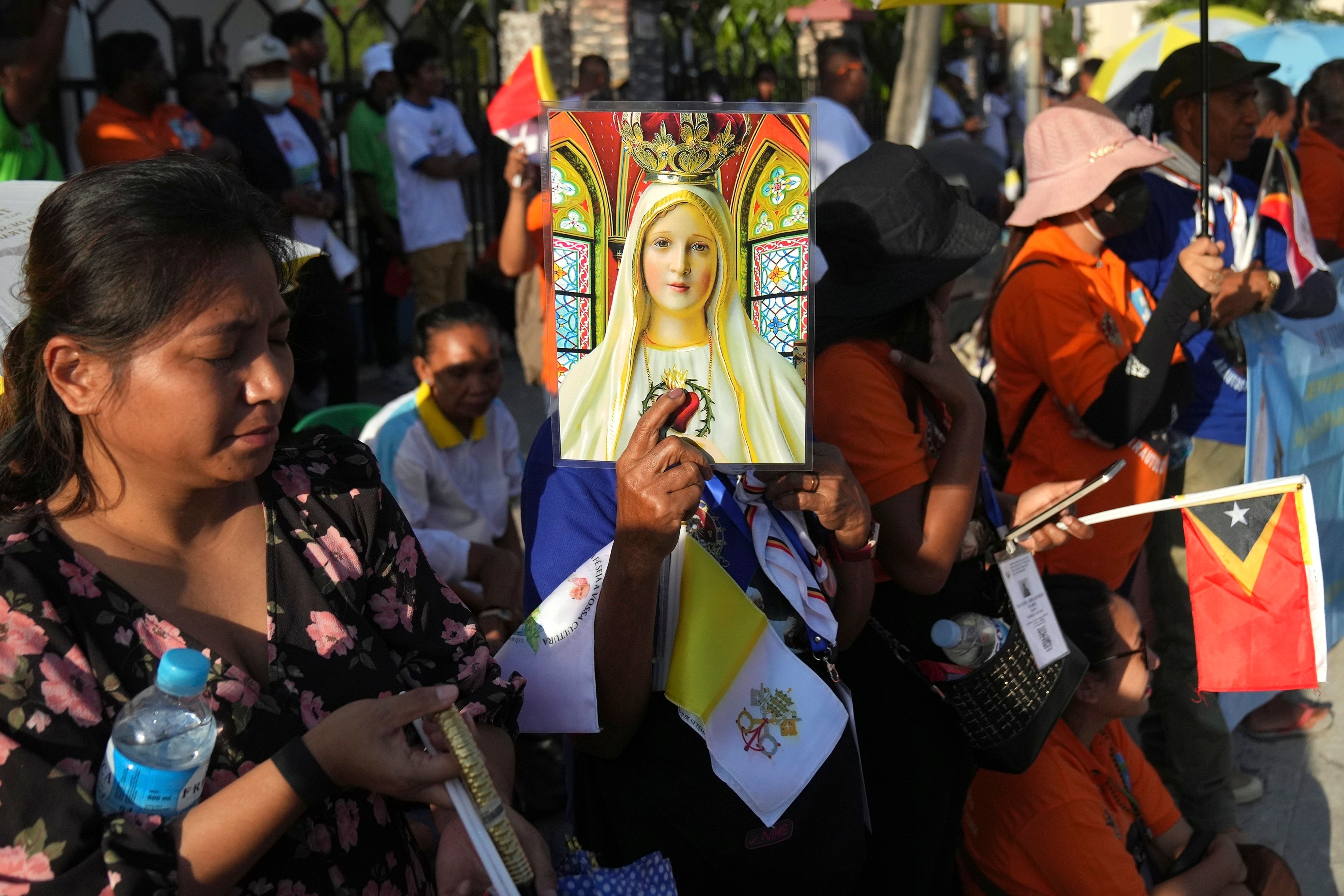 People wait for Pope Francis visiting to children with disabilities of the Irmas Alma School in Dili, East Timor, Tuesday, Sept. 10, 2024. (AP Photo/Dita Alangkara)