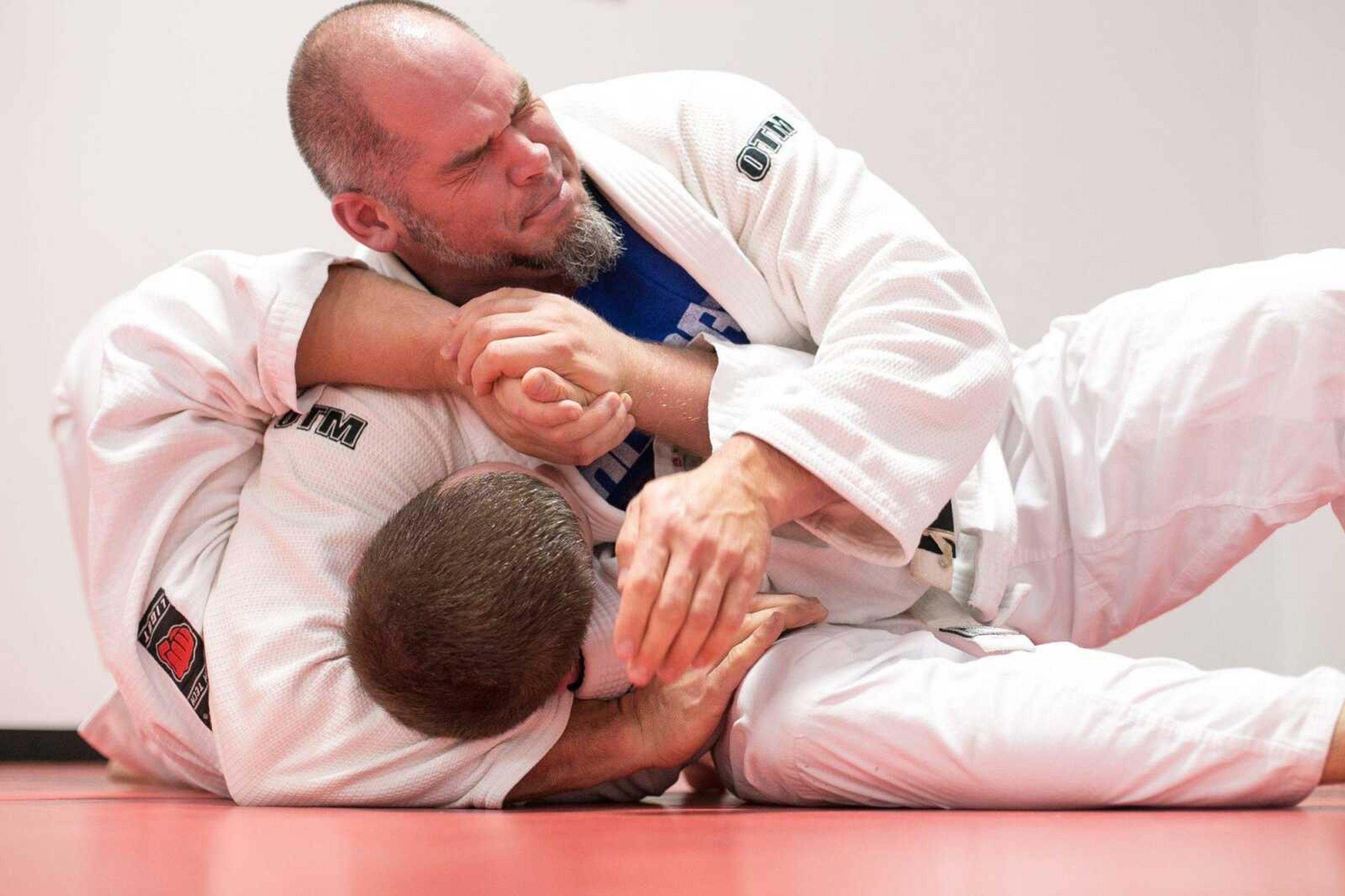 Chris Gideon, top, and Chris Hartlein practice headlock escape tactics during a fundamentals class Tuesday at Gracie Jiu-Jitsu of Southeast Missouri in Jackson. (Glenn Landberg)