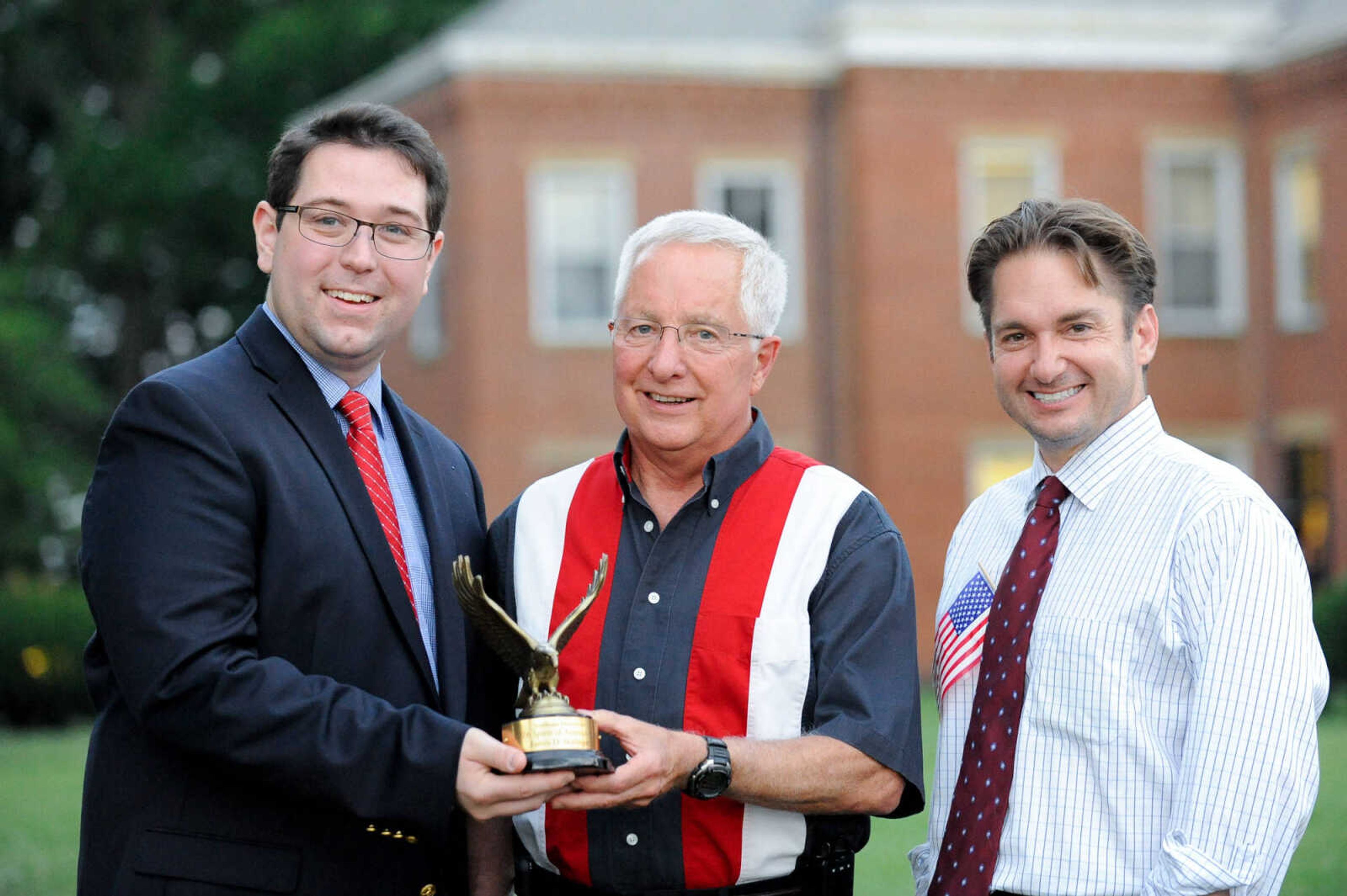 GLENN LANDBERG ~ glandberg@semissourian.com

Lucas Presson, left, general manager of rustmedia, and Jon K. Rust, publisher of the Southeast Missourian and co-president of Rust Communications, stand with James D. Bollinger, the 2016 Spirit of America award winner Monday, July 4, 2016 at the Common Pleas Courthouse in Cape Girardeau.