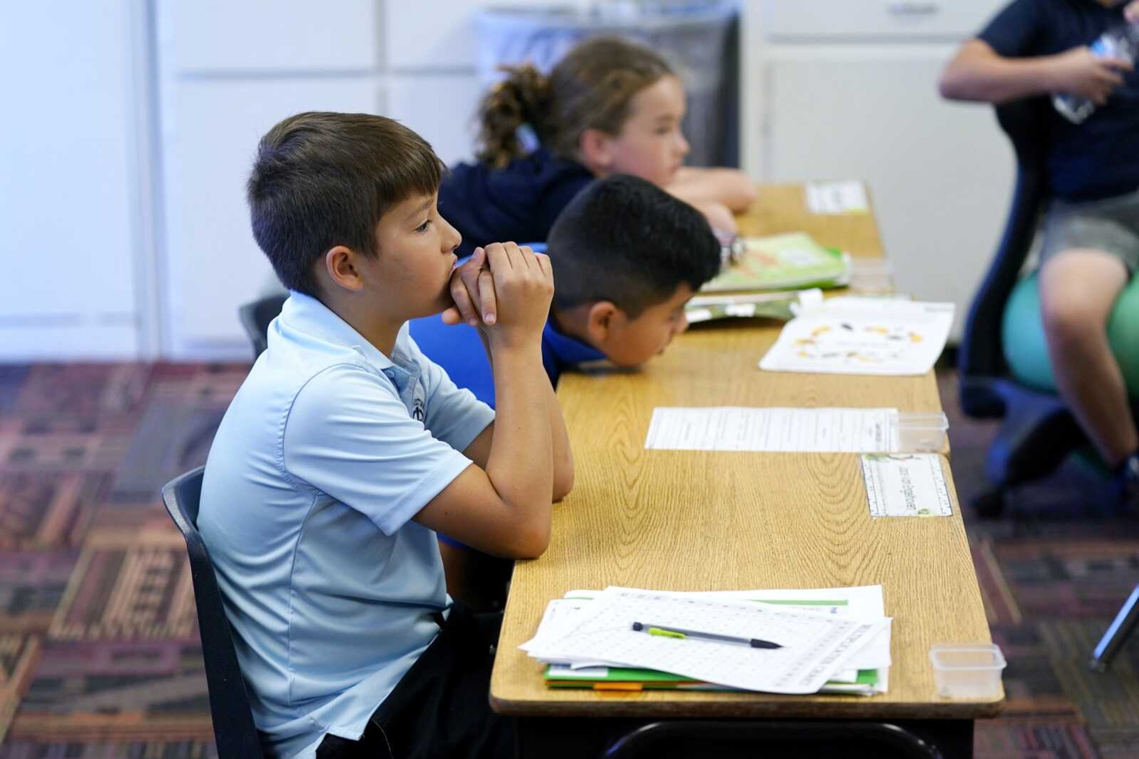 Students listen to their teacher during a class at Phoenix Christian School PreK-8 on Tuesday, Oct. 25, in Phoenix.