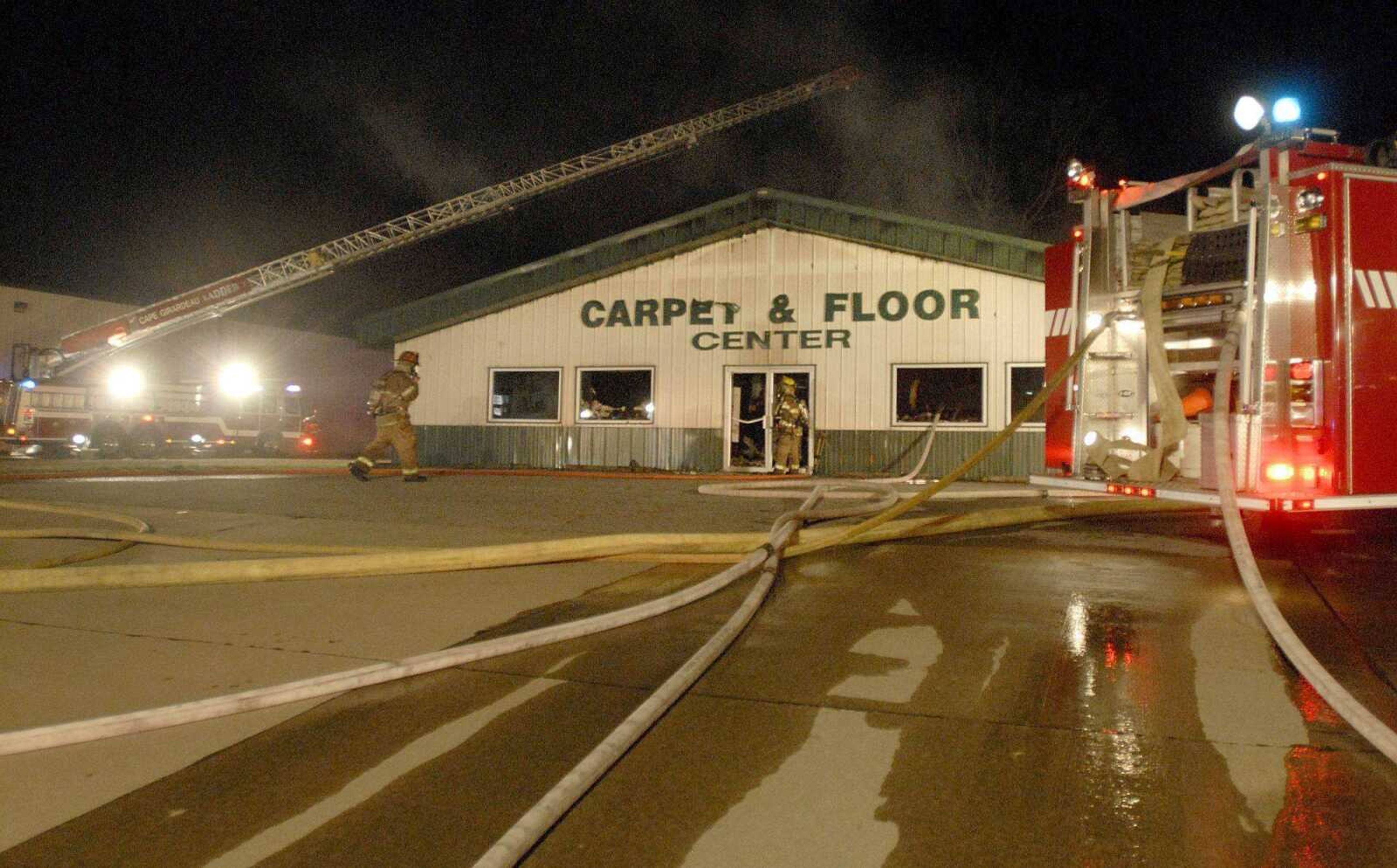 Area rescue departments respond to a structure fire at the Carpet &amp; Floor Center located at 592 Commercial Street in Cape Girardeau Monday evening. (LAURA SIMON)