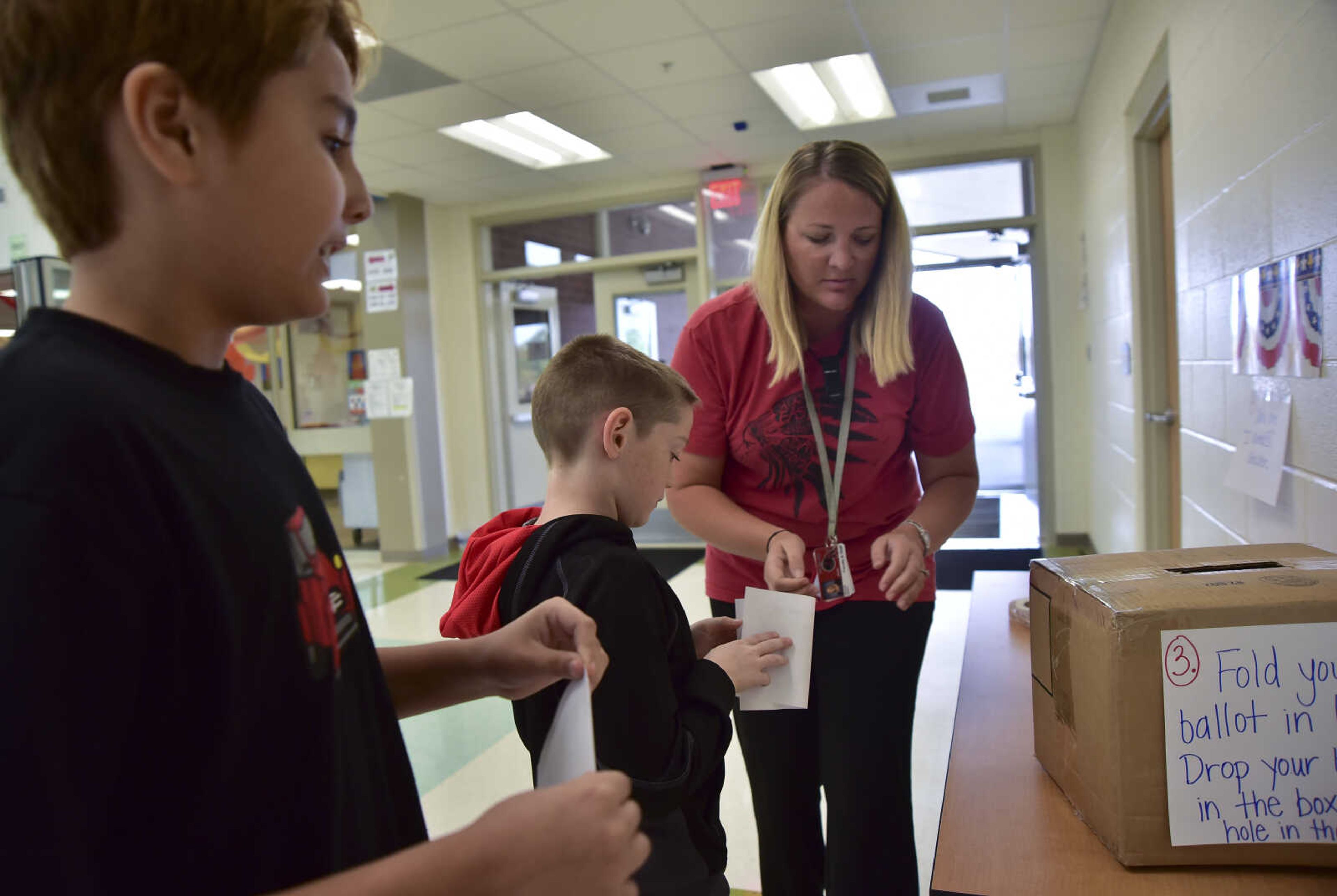 ANDREW J. WHITAKER ~ awhitaker@semissourian.com
Megan Sides, right, receives ballots from Trenton Unterreiner and Colt Anderson during a mock election Tuesday, Nov. 8, 2016 at East Elementary in Jackson.