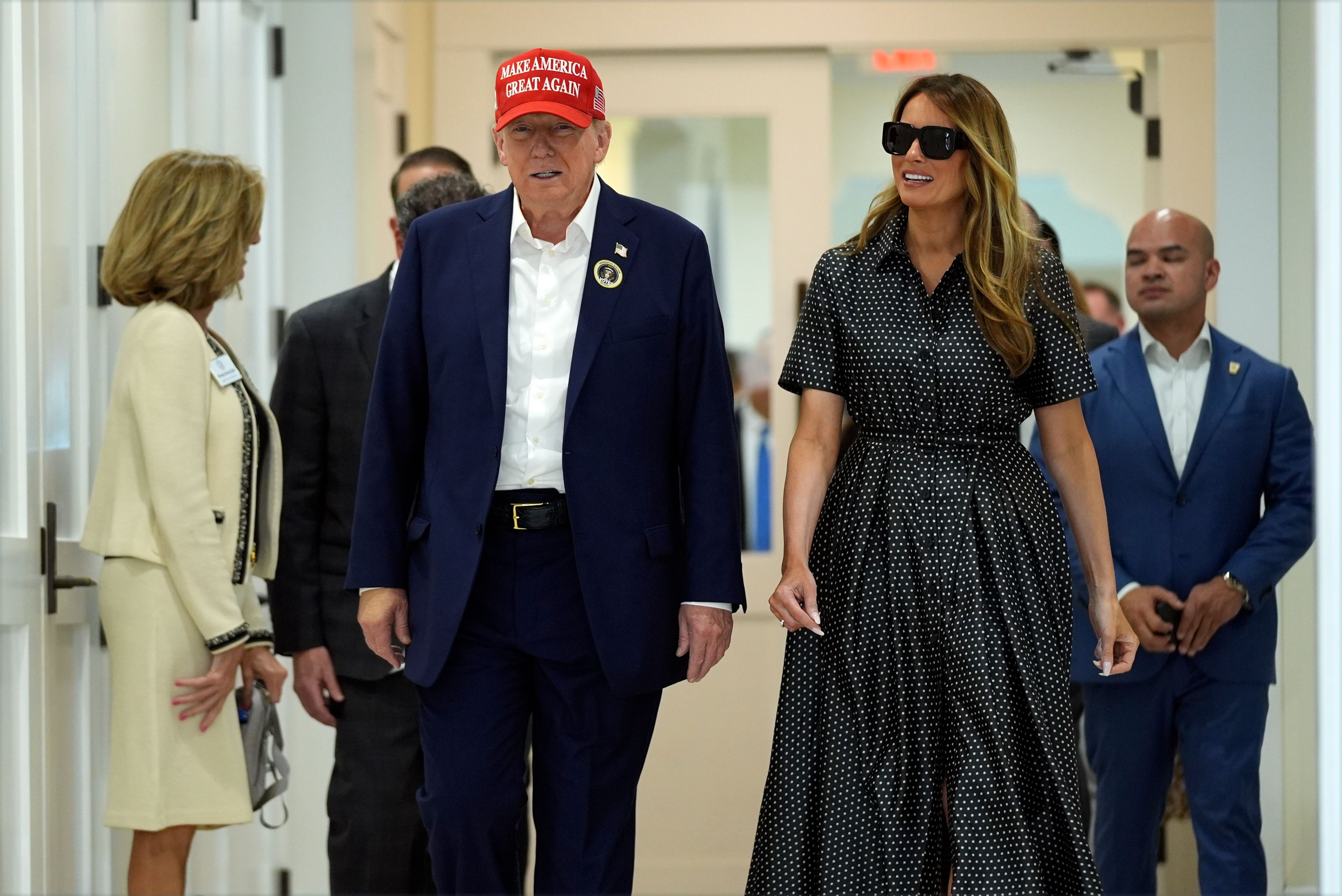 Republican presidential nominee former President Donald Trump and former first lady Melania Trump walk after voting on Election Day at the Morton and Barbara Mandel Recreation Center, Tuesday, Nov. 5, 2024, in Palm Beach, Fla. (AP Photo/Evan Vucci)