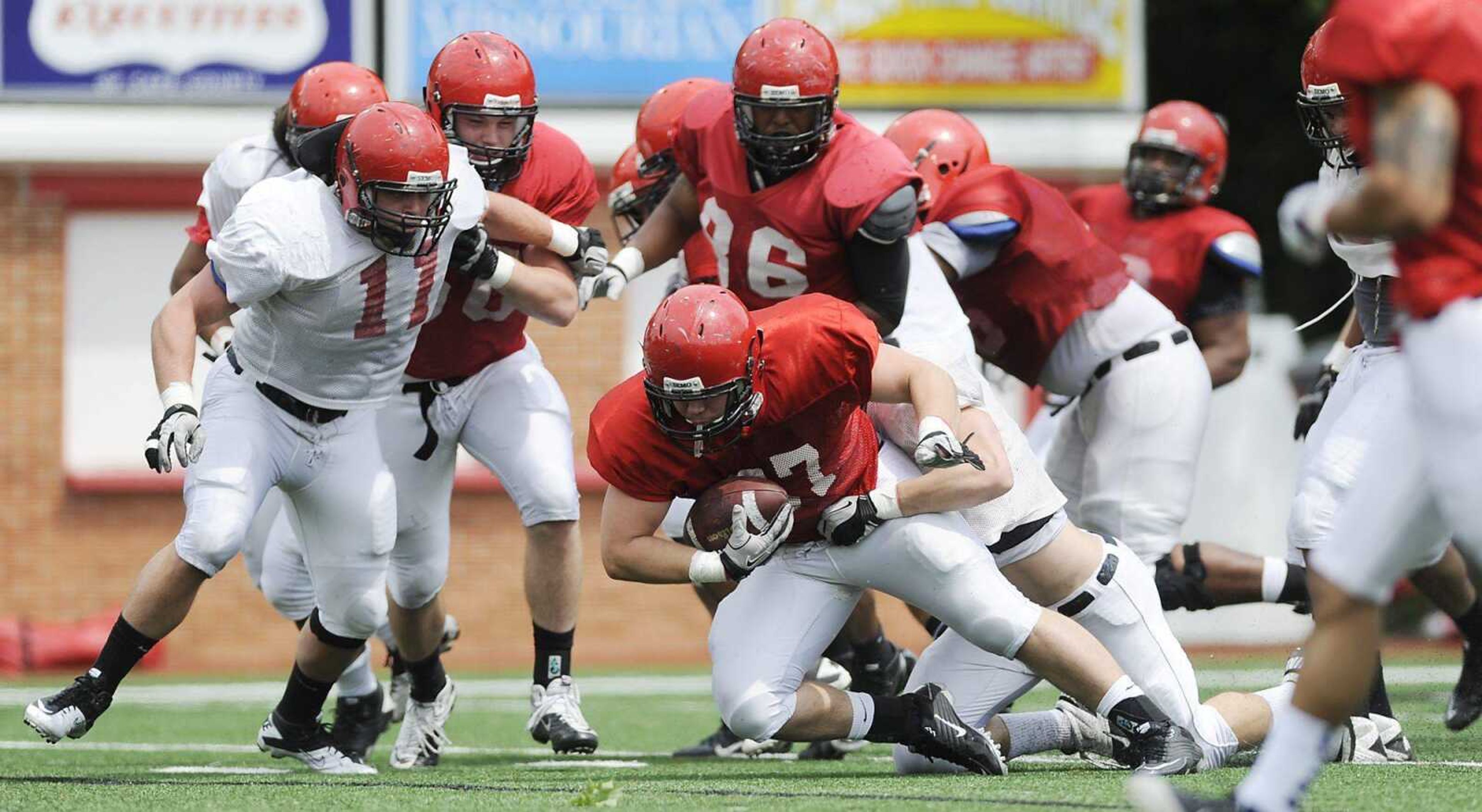 Southeast Missouri State running back Levi Terrell gets tackled by the defense during Saturday's scrimmage at Houck Stadium. (ADAM VOGLER)