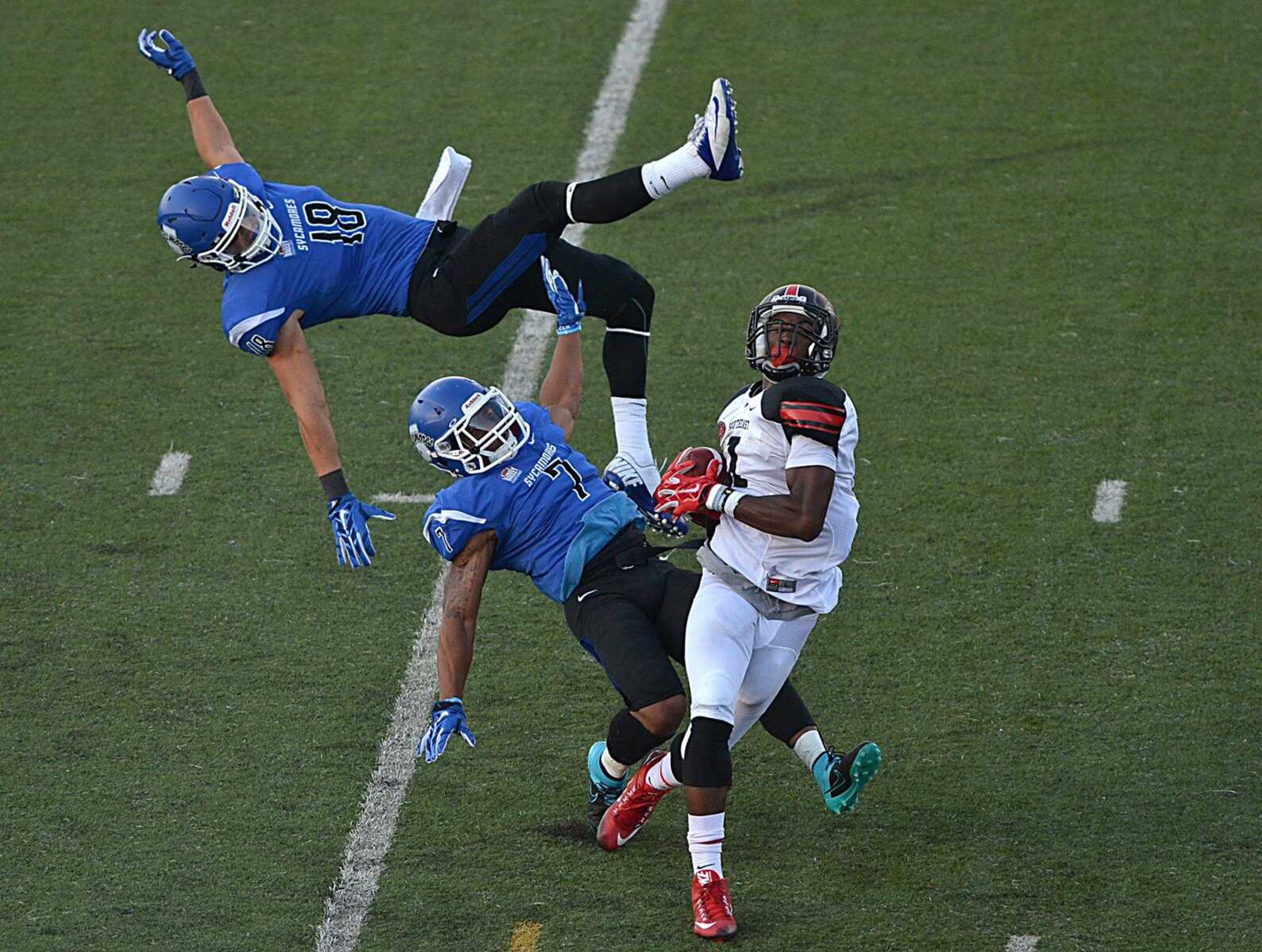 Southeast Missouri State's Paul McRoberts comes away with a catch while being defended by Indiana State's Robert Tonyan, Jr., top, and Travis Starks in the final seconds of Saturday's game in Terre Haute, Indiana. (Joseph C. Garza ~ Terre Haute Tribune Star)