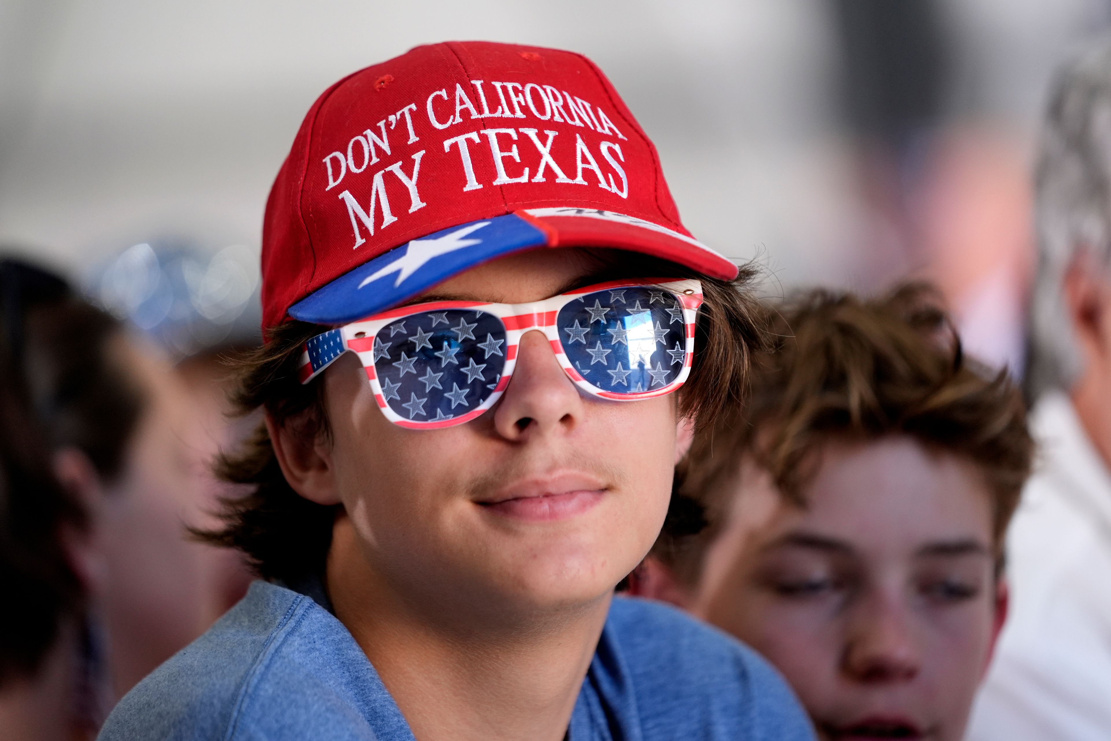 An attendee waits for Republican presidential nominee former President Donald Trump to speak at a news conference at Austin-Bergstrom International Airport, Friday, Oct. 25, 2024, in Austin, Texas. (AP Photo/Alex Brandon)