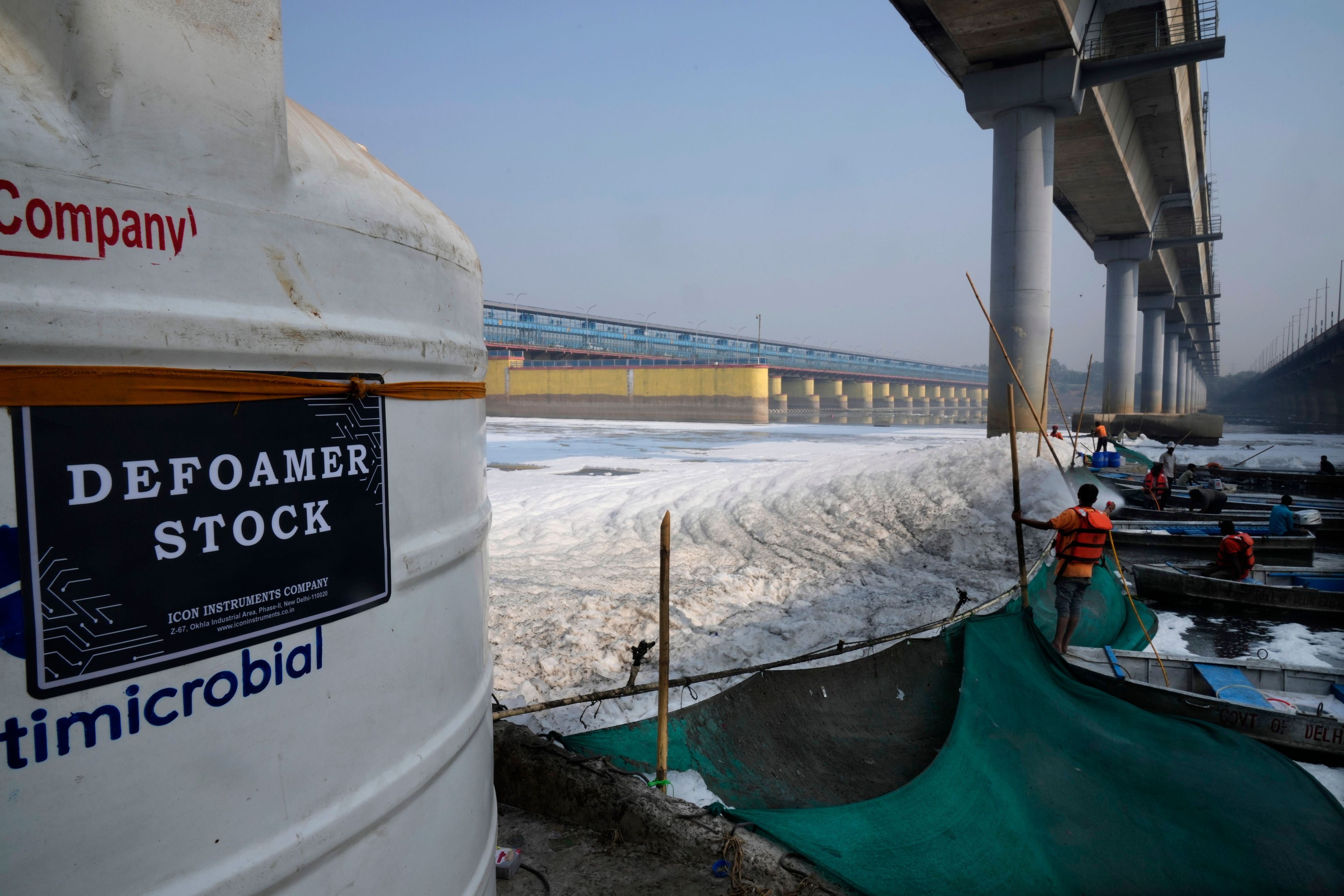 Workers for the Delhi Jal or water board spray chemical to clean the toxic foams in the river Yamuna in New Delhi, India, Tuesday, Oct. 29, 2024. (AP Photo/Manish Swarup)