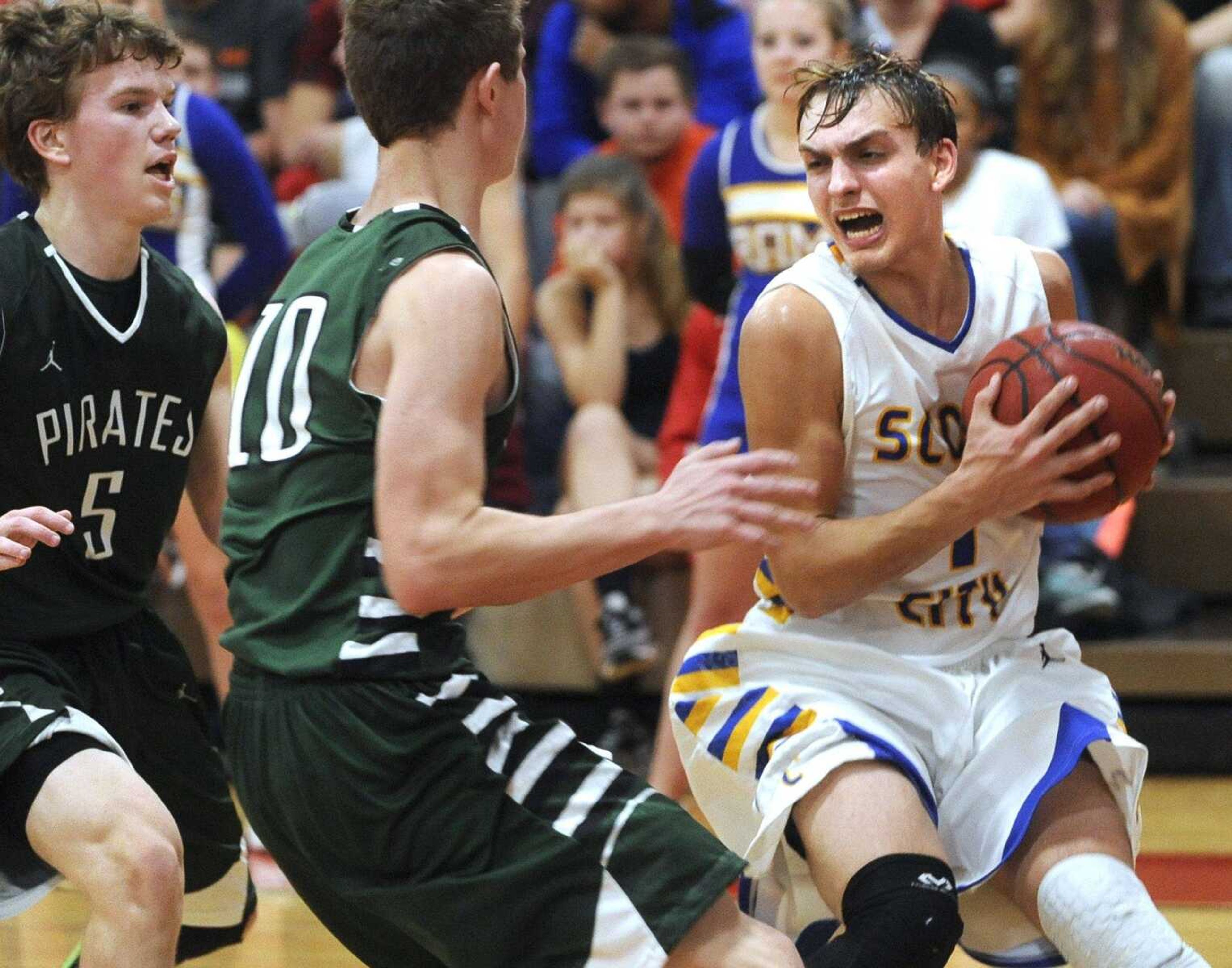 Scott City's Dylan Keller looks for a way past Perryville's Conner Stark as McGwire Bartley looks on during the second quarter of the championship game in the Woodland Invitational on Friday, Dec. 4, 2015 in Marble Hill, Missouri. (Fred Lynch)