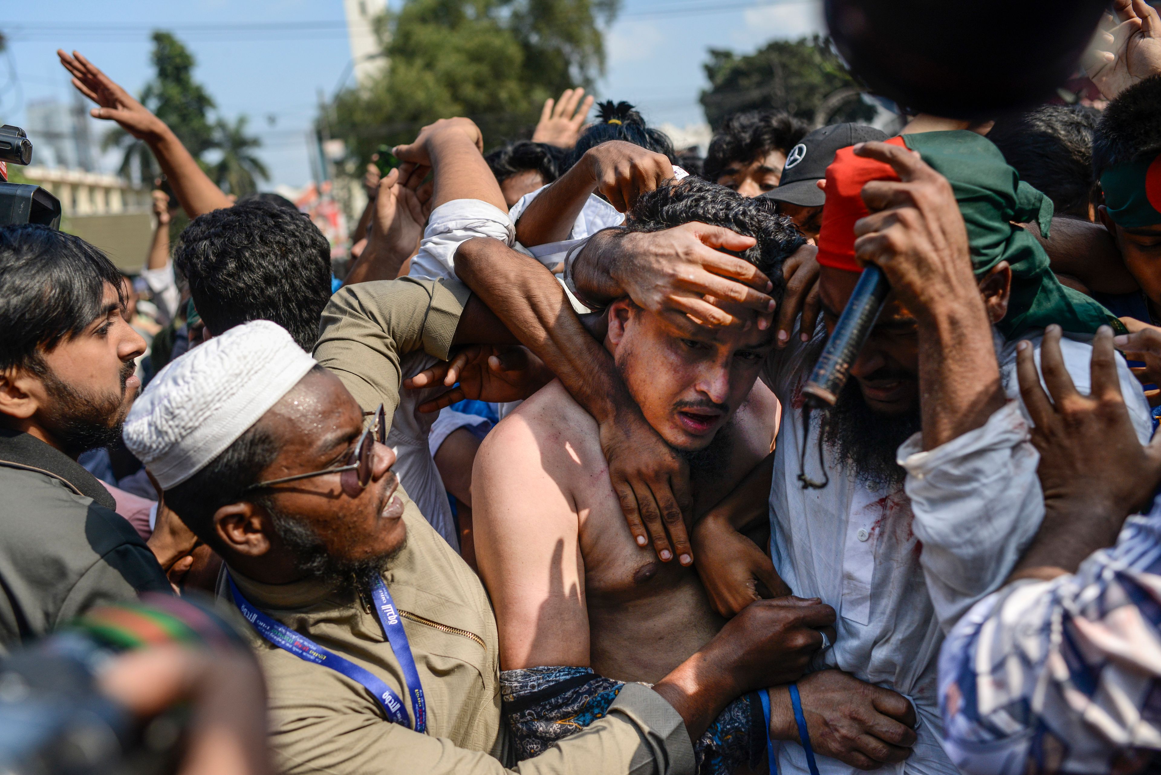 Students from anti-discrimination movements attack an Awami League supporter in Dhaka, Bangladesh, Sunday, Nov. 10, 2024. (AP Photo/Mahmud Hossain Opu)