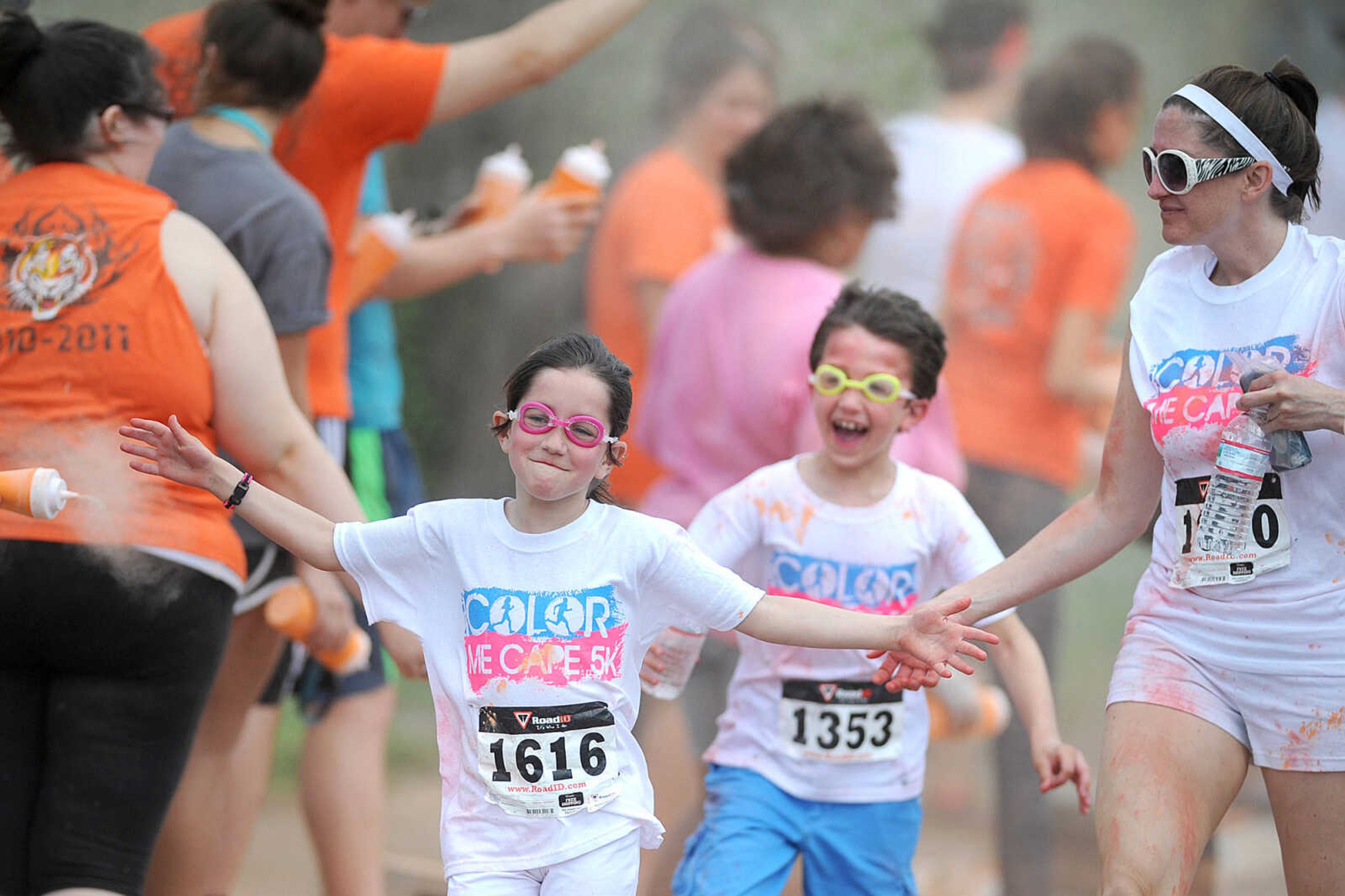 LAURA SIMON ~ lsimon@semissourian.com

Participants in the Color Me Cape 5K are sprayed with orange powder at the first color station on Good Hope Street, Saturday, April 12, 2014, in Cape Girardeau.