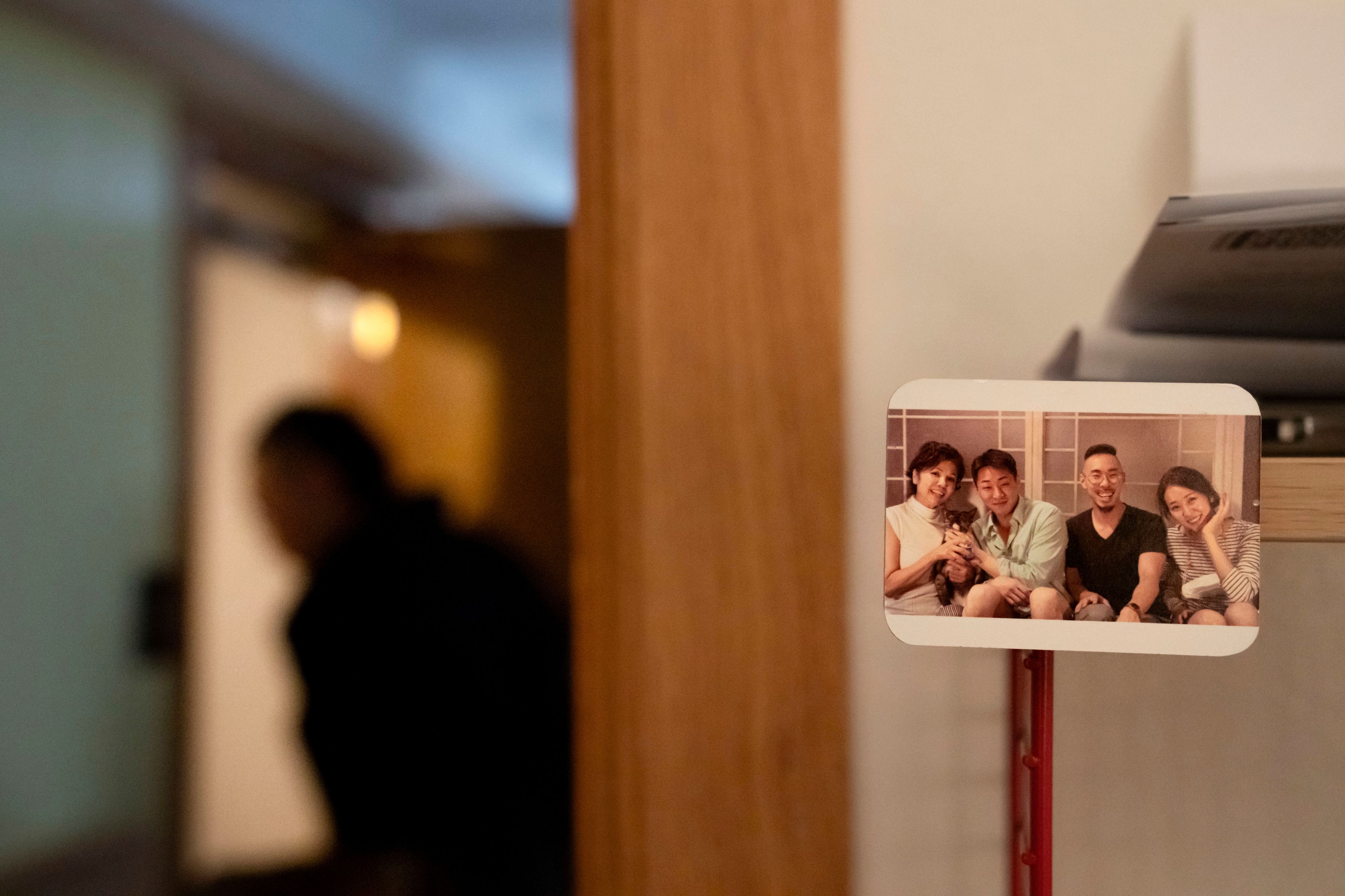 A photo magnet of Robert Calabretta, second from right, when he reunited with his biological mother, left, and siblings, decorates his apartment, Friday, Feb. 16, 2024, in New York. He prefers his new name now: Hanil Lee. (AP Photo/David Goldman)