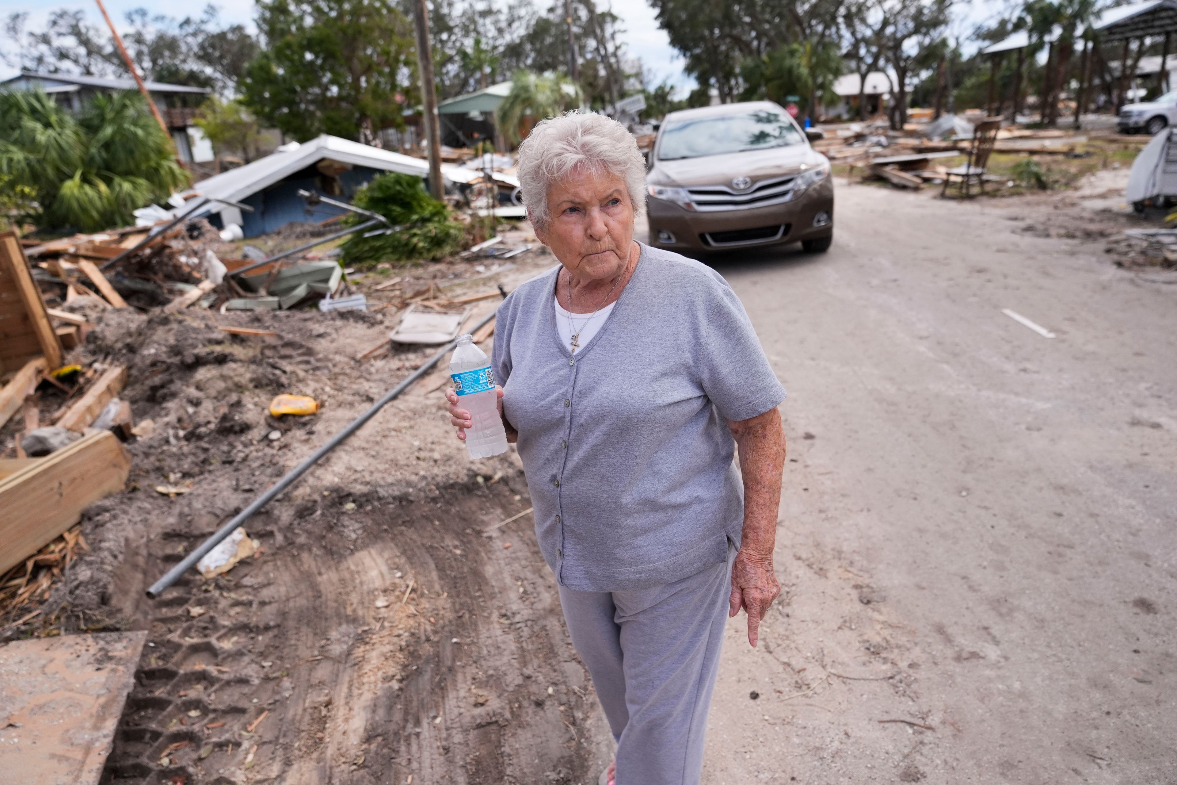 Elsie Hicks looks at the destruction of the home she has lived in for 25 years, in the aftermath of Hurricane Helene, in Horseshoe Beach, Fla., Saturday, Sept. 28, 2024. (AP Photo/Gerald Herbert)