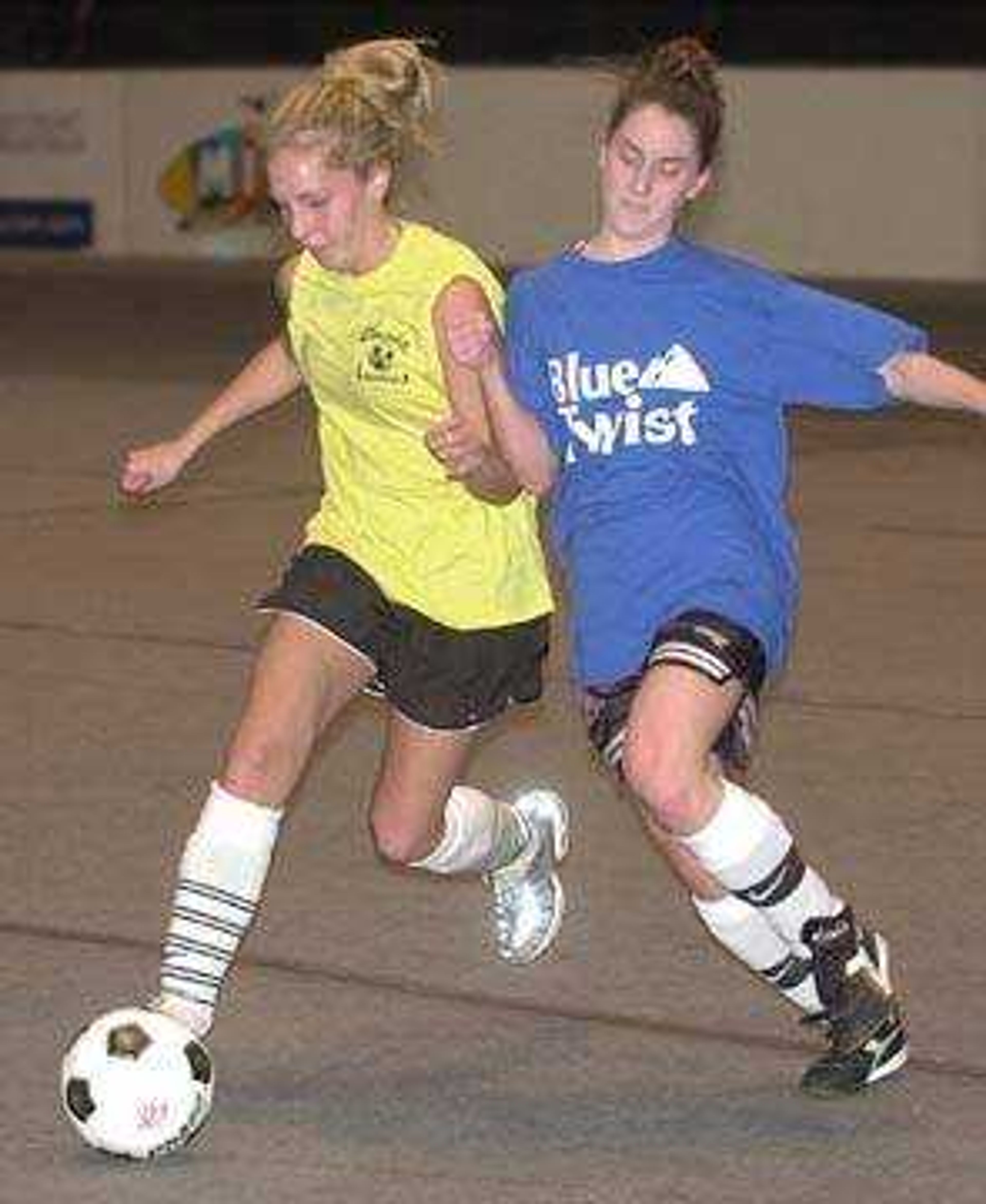 Lauren Thompson, left, with Cape Classic Girls worked the ball past Brittany Little with Blue Twist.