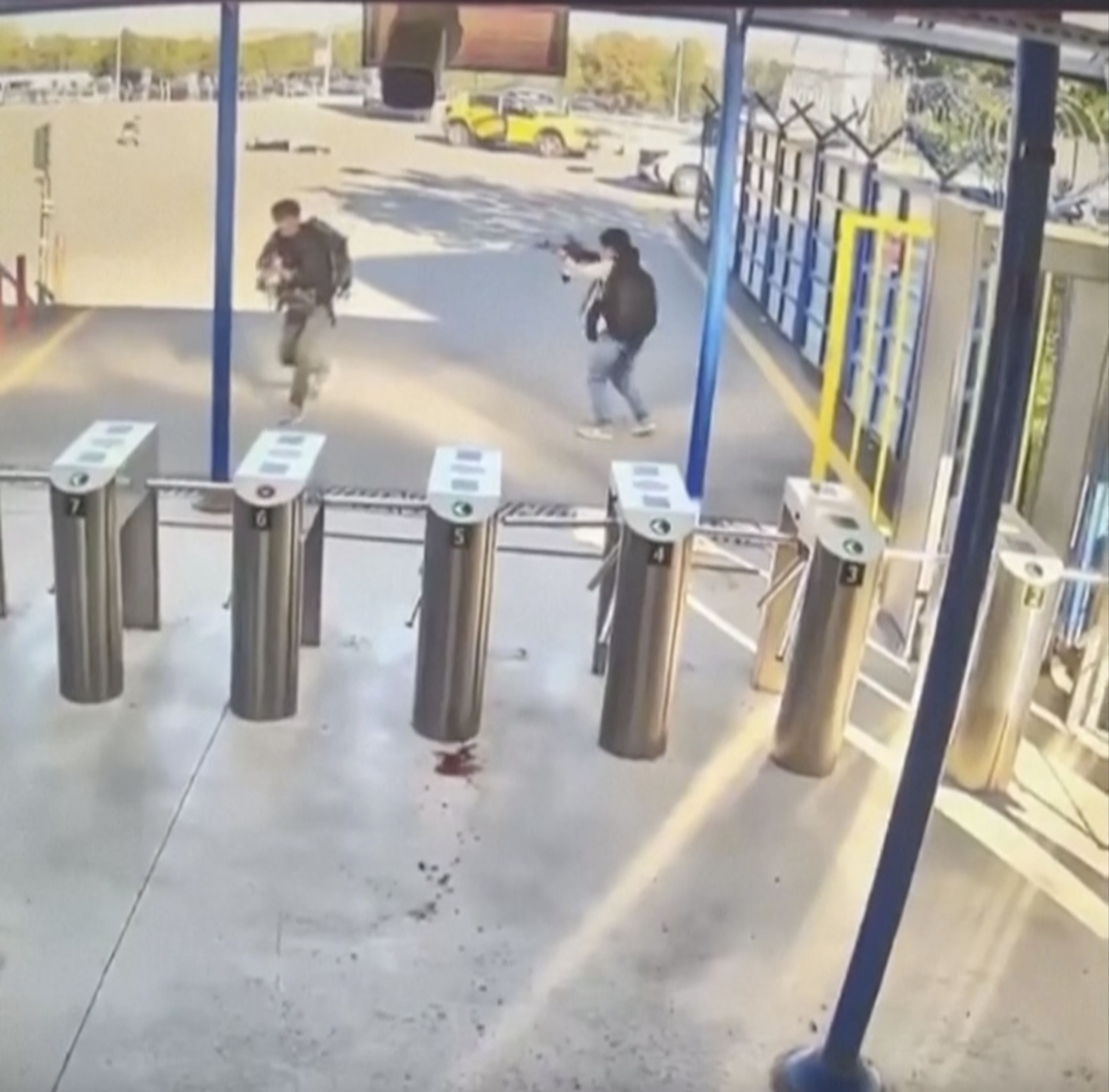 In this image take from security camera video shows two people with guns and backpacks during an attack on the premises of the Turkish state-run aerospace and defence company (TUSAS ), on the outskirts of Ankara, Turkey, Wednesday Oct. 23, 2024. (Validated UGC via AP)