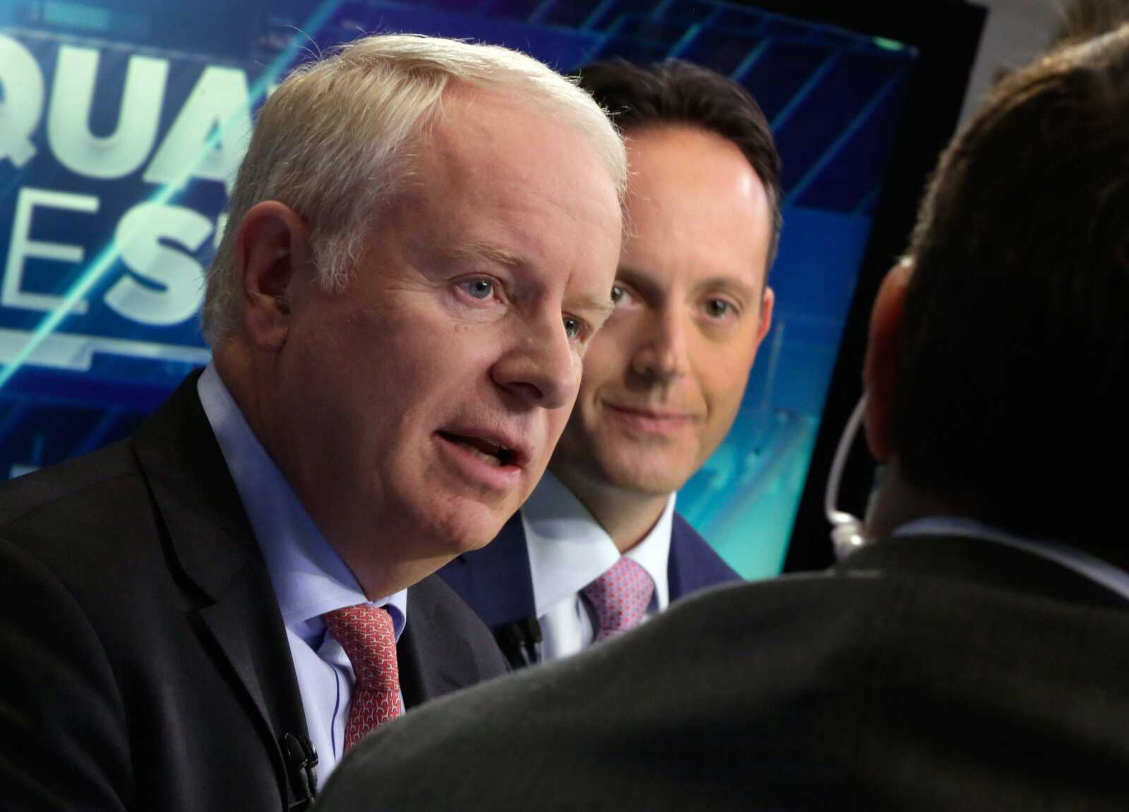 Allergan CEO David Pyott, left, and Actavis CEO Brenton Saunders are interviewed Nov. 17 on the floor of the New York Stock Exchange. Pyott is set to rake in an estimated $100 million in "golden parachute" payments, according to a study done by pay-tracking firm Equilar. (Richard Drew ~ Associated Press)