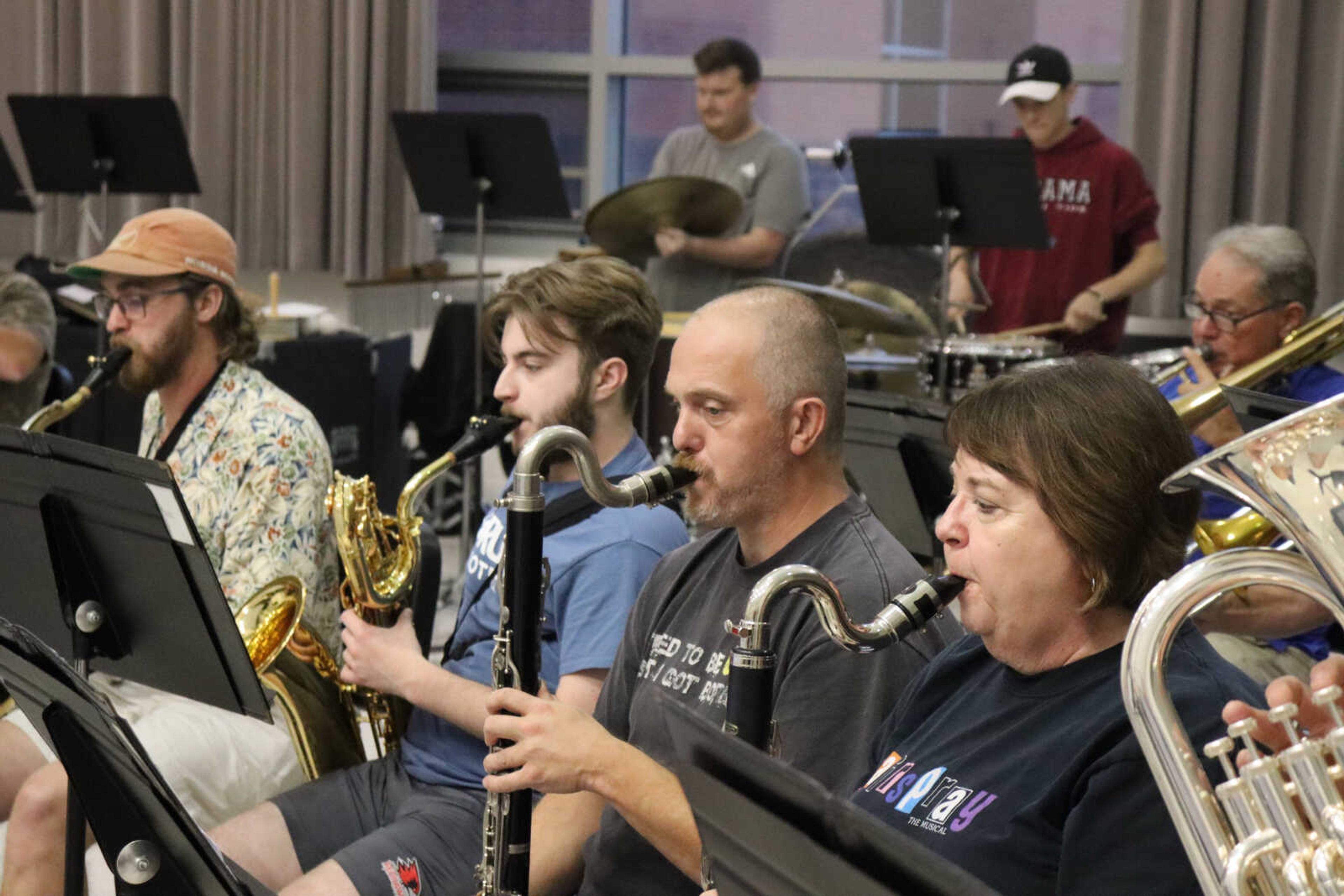 (Left) Saxophones Ethan Flood and Clayton Seabaugh then bass clarinets Jesse Bledsoe and Betty Brooks follow through the music in the Jackson Municipal Band practice.