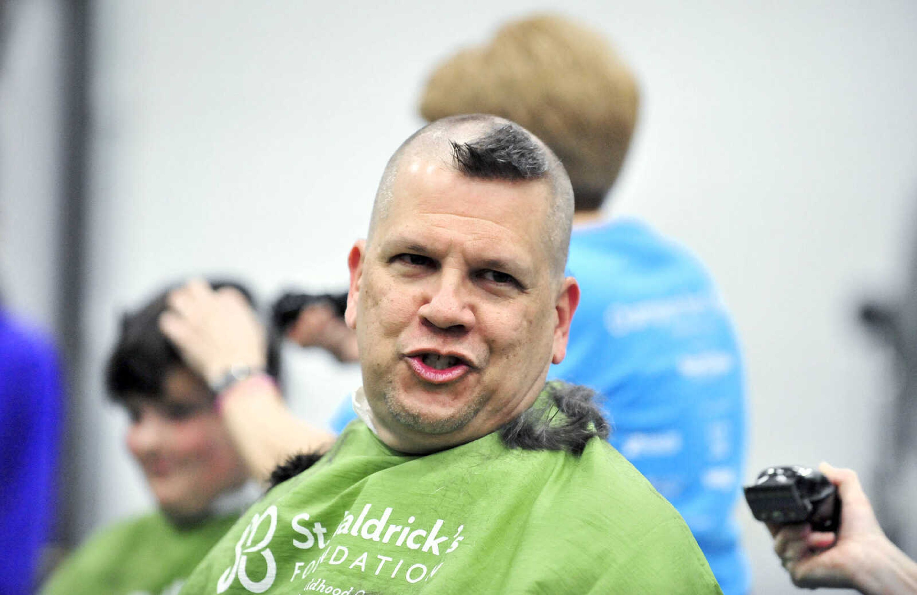 Jackson school superintendent John Link reacts as April Whiteside shaves his head on Saturday, March 4, 2017, during the St. Baldrick's Foundation fundraiser at Old Orchard CrossFit in Jackson.