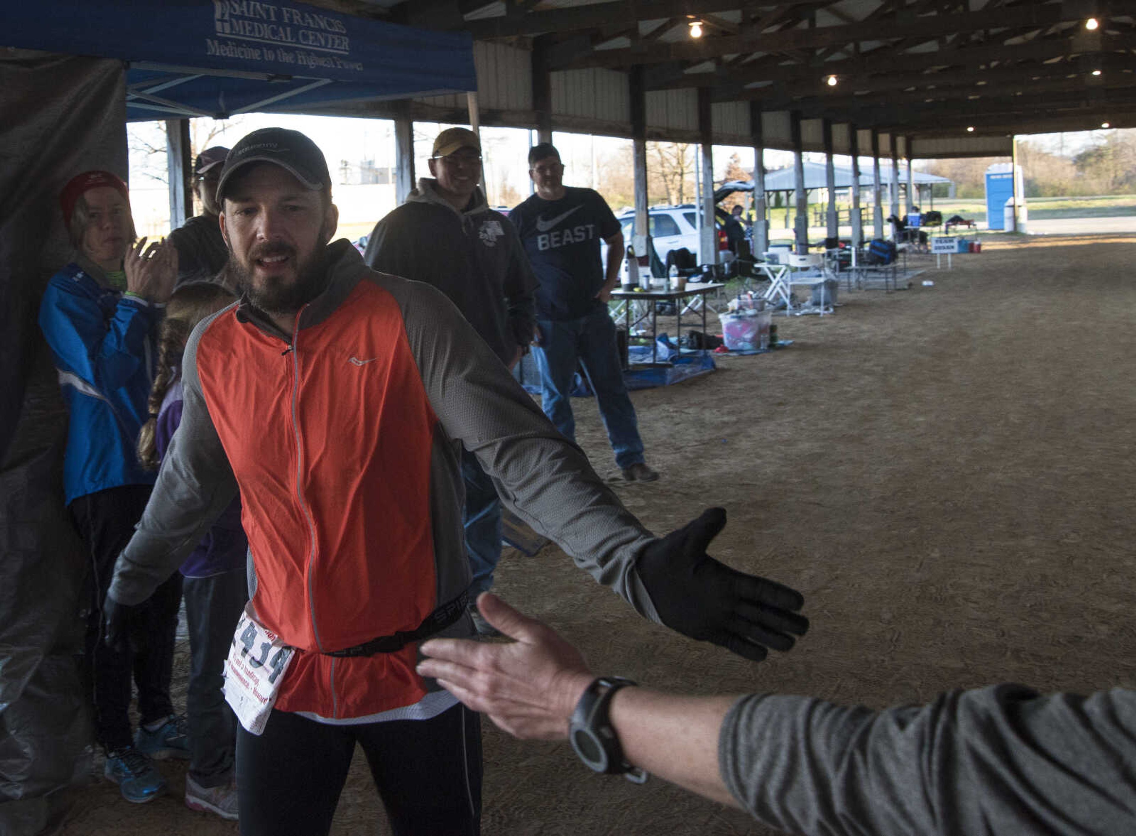 David Pepon is high fives as he finishes with 100 miles for the 8th annual Howard Aslinger Endurance Run on Friday, March 17, 2017 in Cape Girardeau.