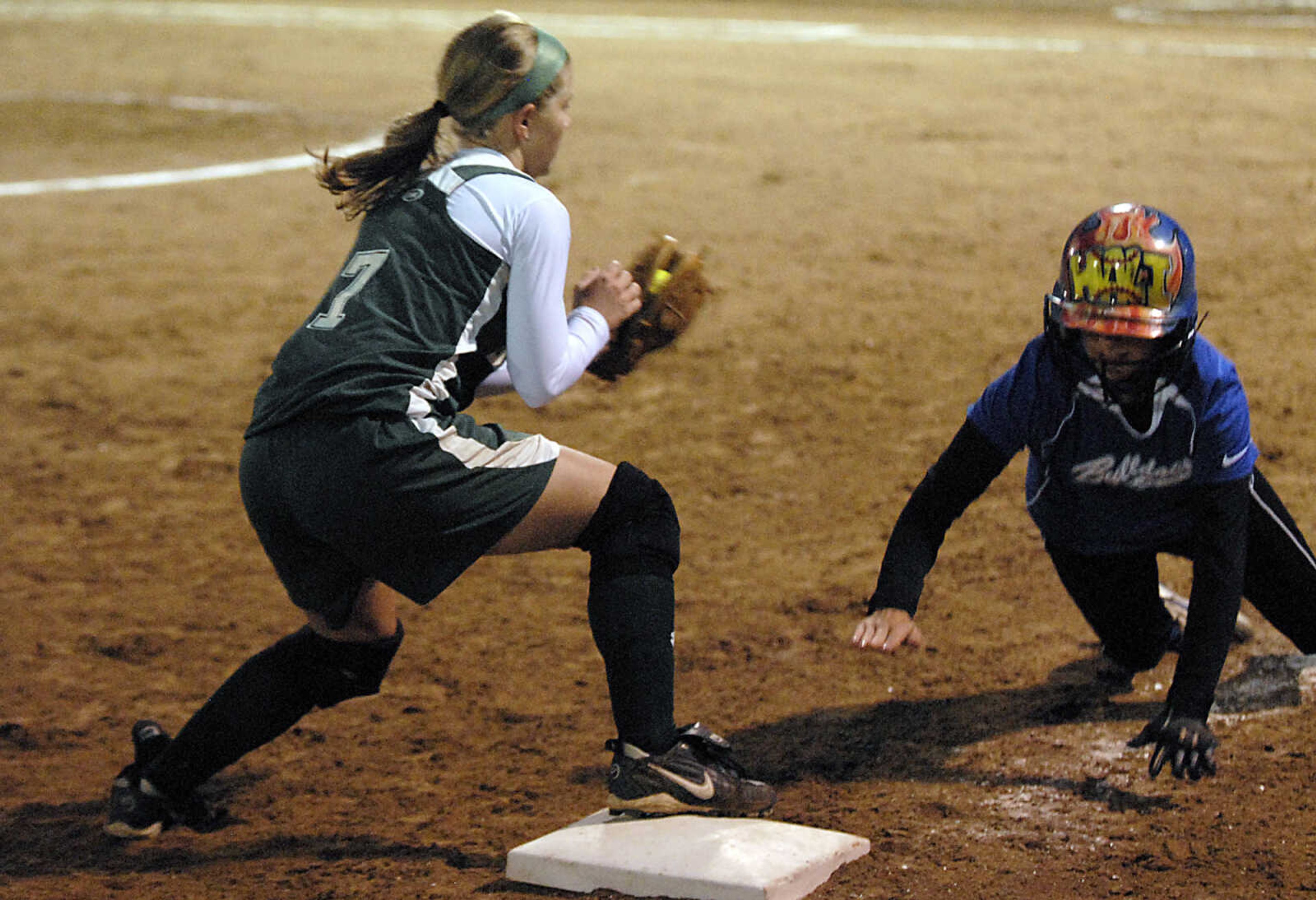 KIT DOYLE ~ kdoyle@semissourian.com
Notre Dame baserunner Hali Rendleman dives back to third base before DeSoto shortstop Kelsey Landholt can tag her on a pickoff play Thursday, October 15, 2009, in Poplar Bluff.