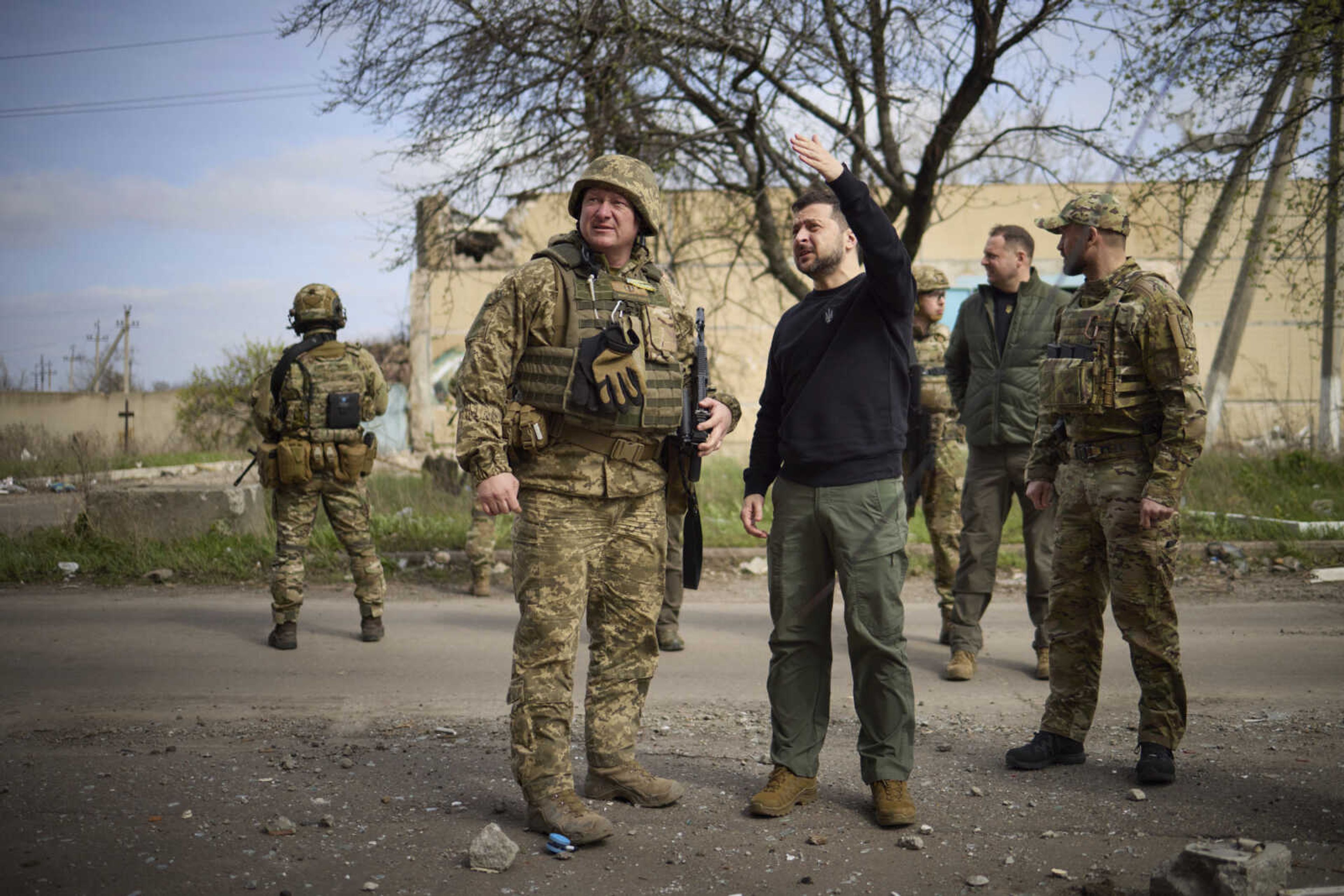 Ukrainian President Volodymyr Zelenskyy talks with a commander Tuesday at a position in Avdiivka, Donetsk region, Ukraine.