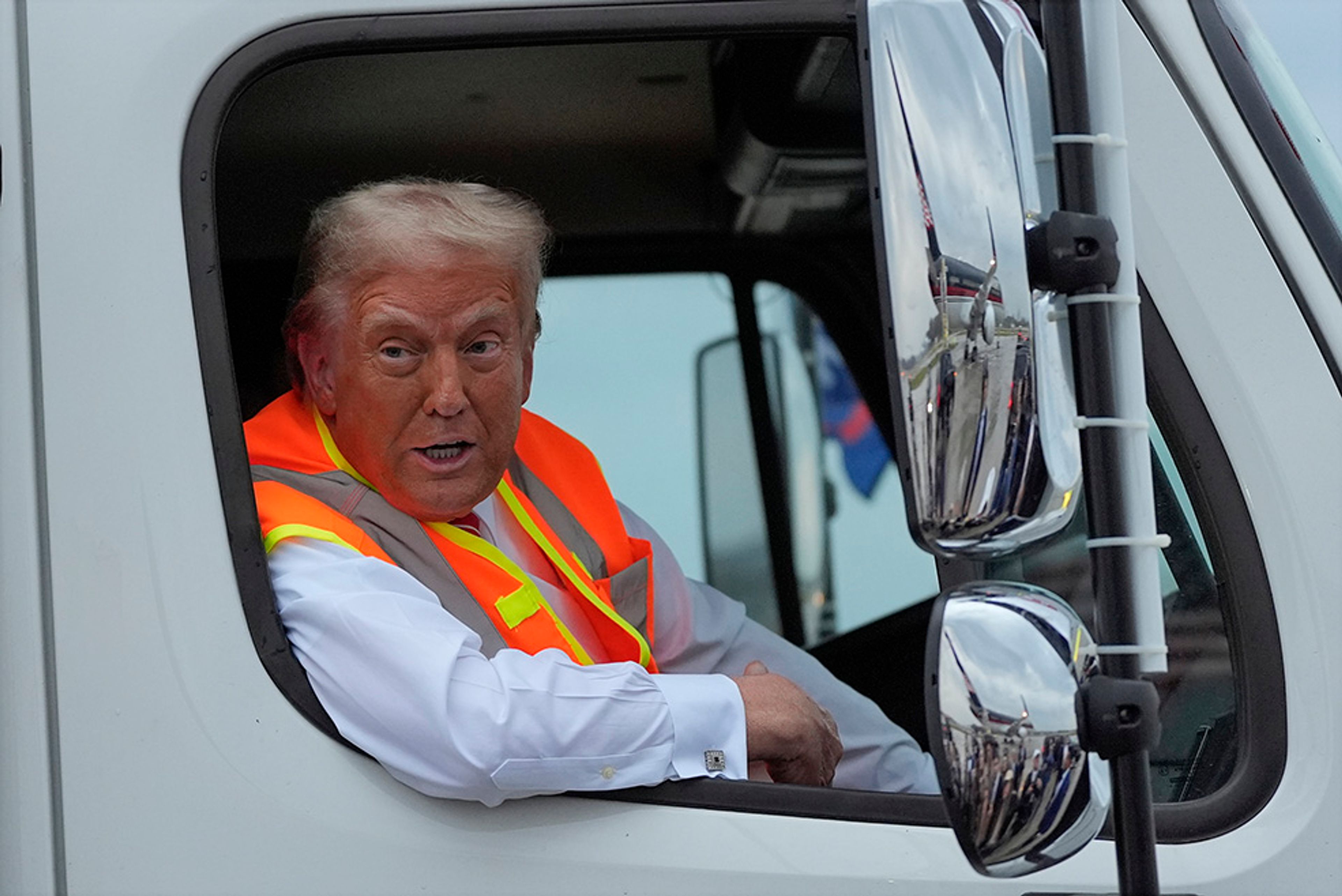 Republican presidential nominee former President Donald Trump talks to reporters as he sits in a garbage truck Wednesday, Oct. 30, 2024, in Green Bay, Wis. 