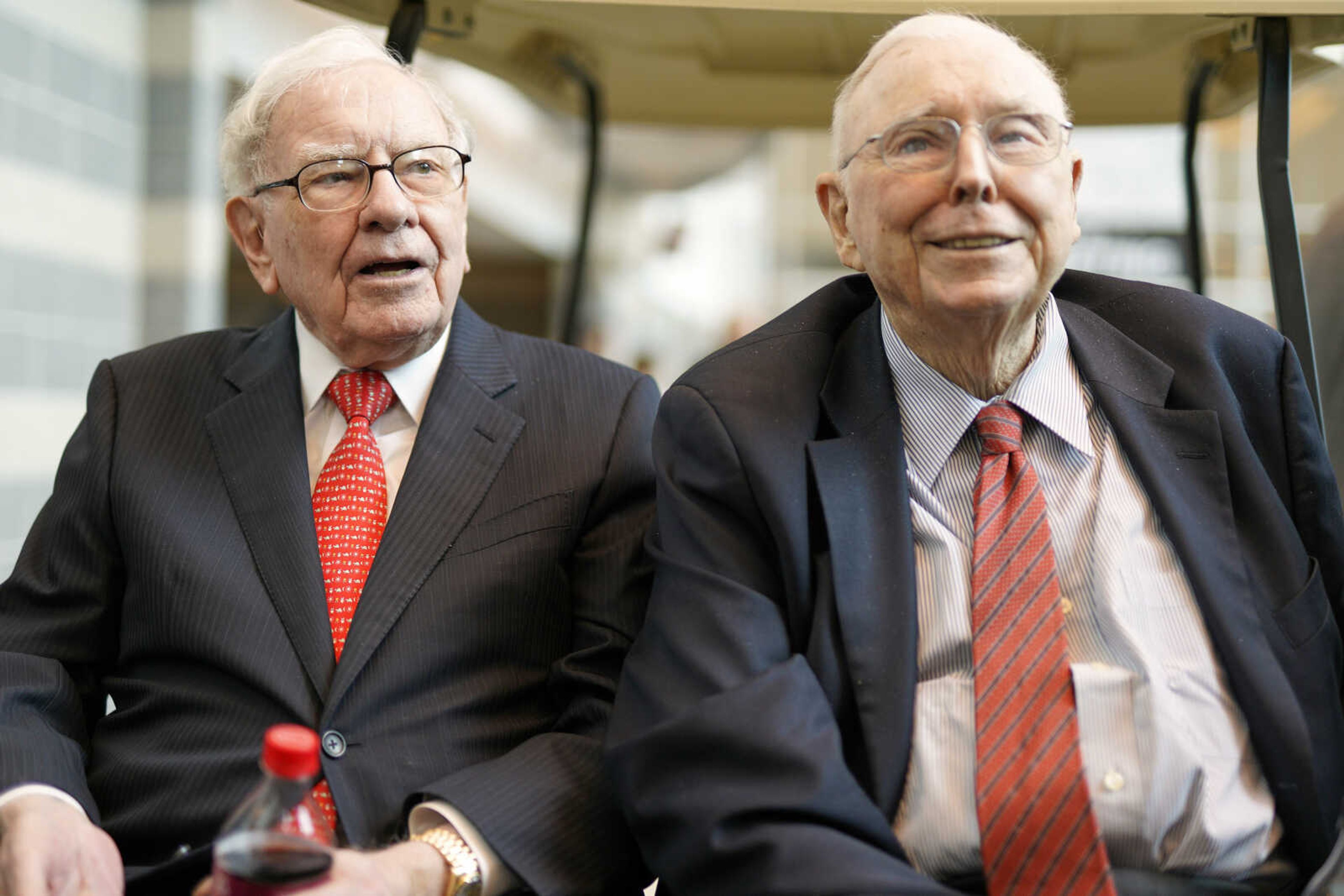 Berkshire Hathaway Chairman and CEO Warren Buffett, left, and Vice Chairman Charlie Munger, briefly chat with reporters May 3, 2019, one day before Berkshire Hathaway's annual shareholders meeting in Omaha, Nebraska.