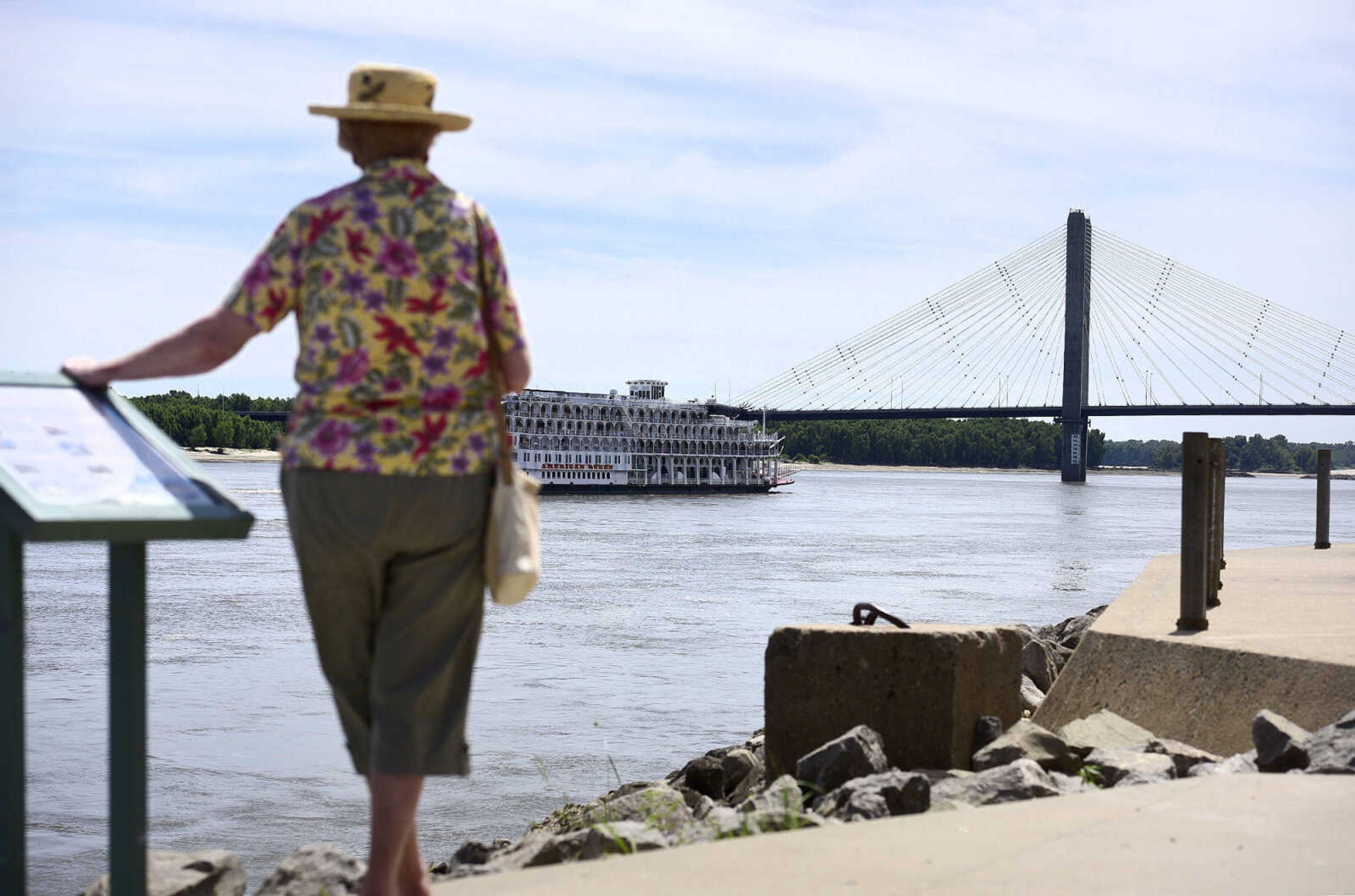 A woman watches the American Queen head south on the Mississippi River on Wednesday, Aug. 23, 2017, from Riverfront Park in downtown Cape Girardeau.