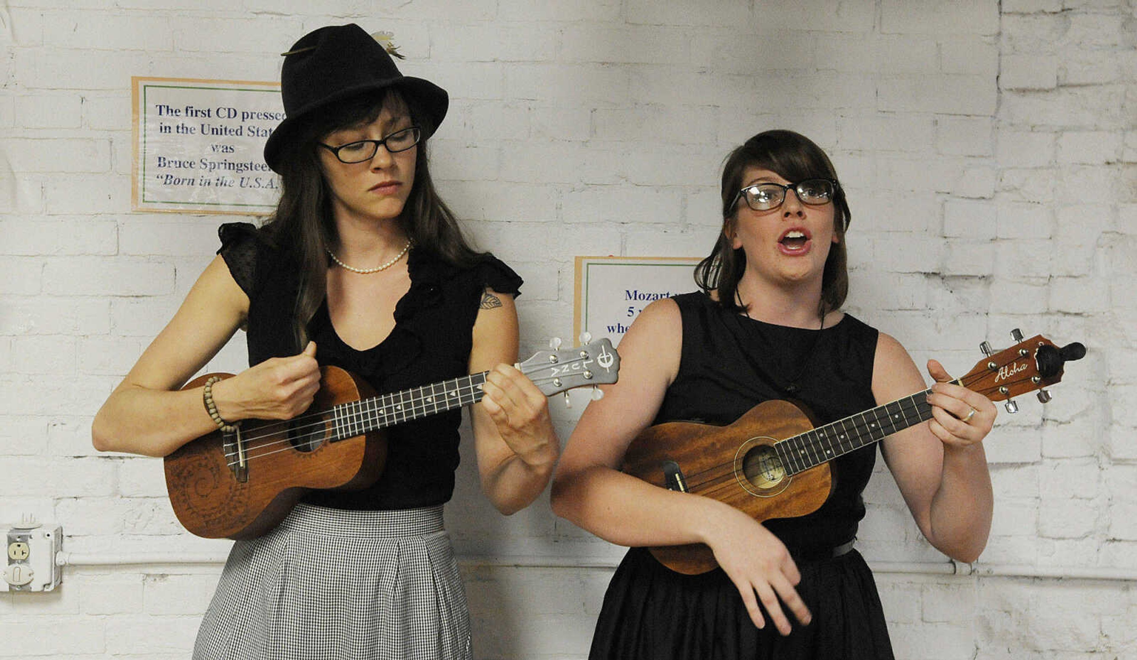 Lumber Jills, JoAnn Miller, left, and Abbie Fieser, play Johnny Cash's 'Ring of Fire,' on the ukulele during the Birdhouse Bash, an annual fundraiser for the Discovery Playhouse Friday night. The Cape Girardeau duo classify themselves as folk traditional. (Adam Vogler)