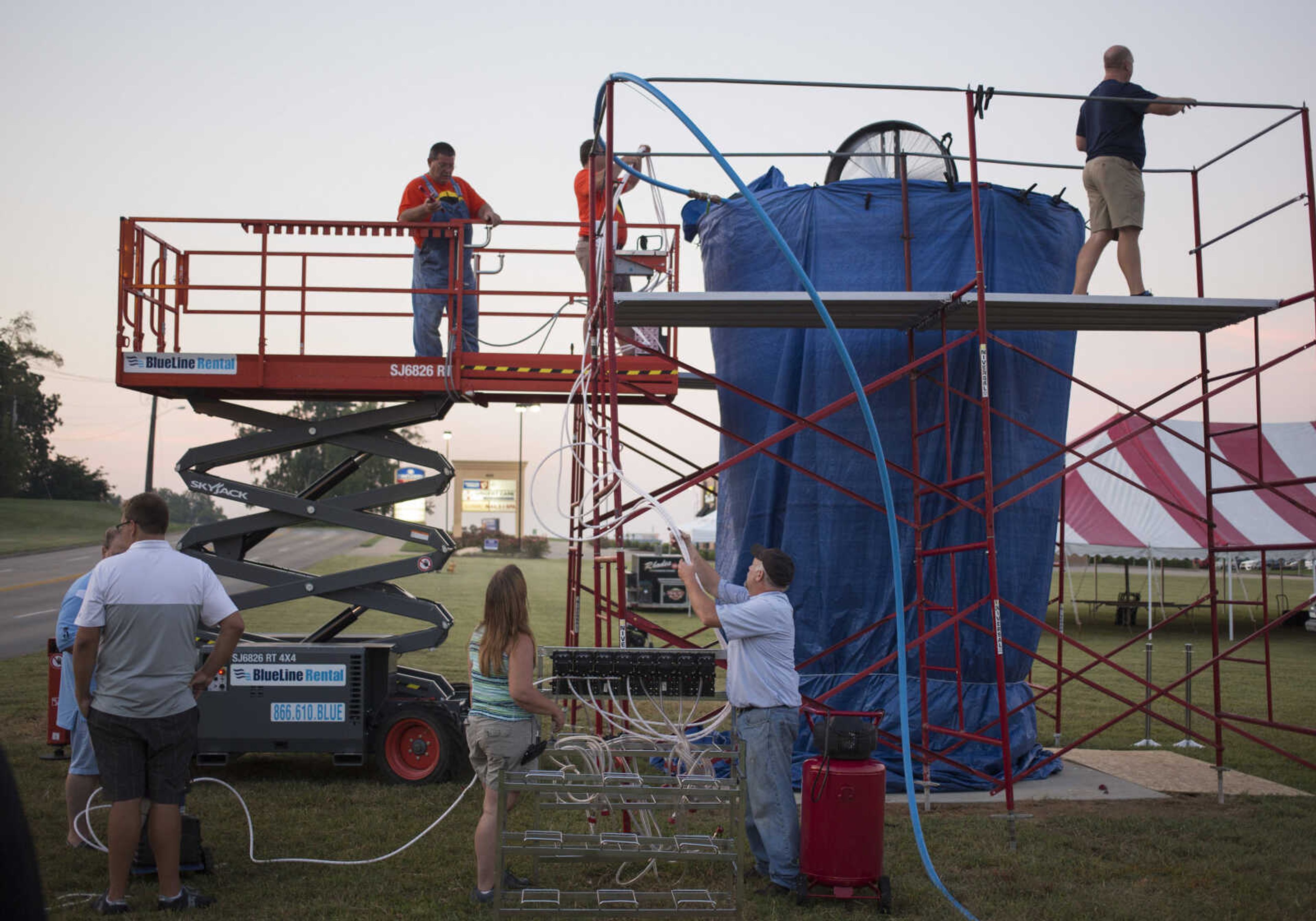 Rhodes employees fill a 15-foot cup with lemonade at Mercato Di Rodi in Cape Girardeau early Sunday morning in an attempt to break the Guinness World Record for largest cup/glass of soft drink.