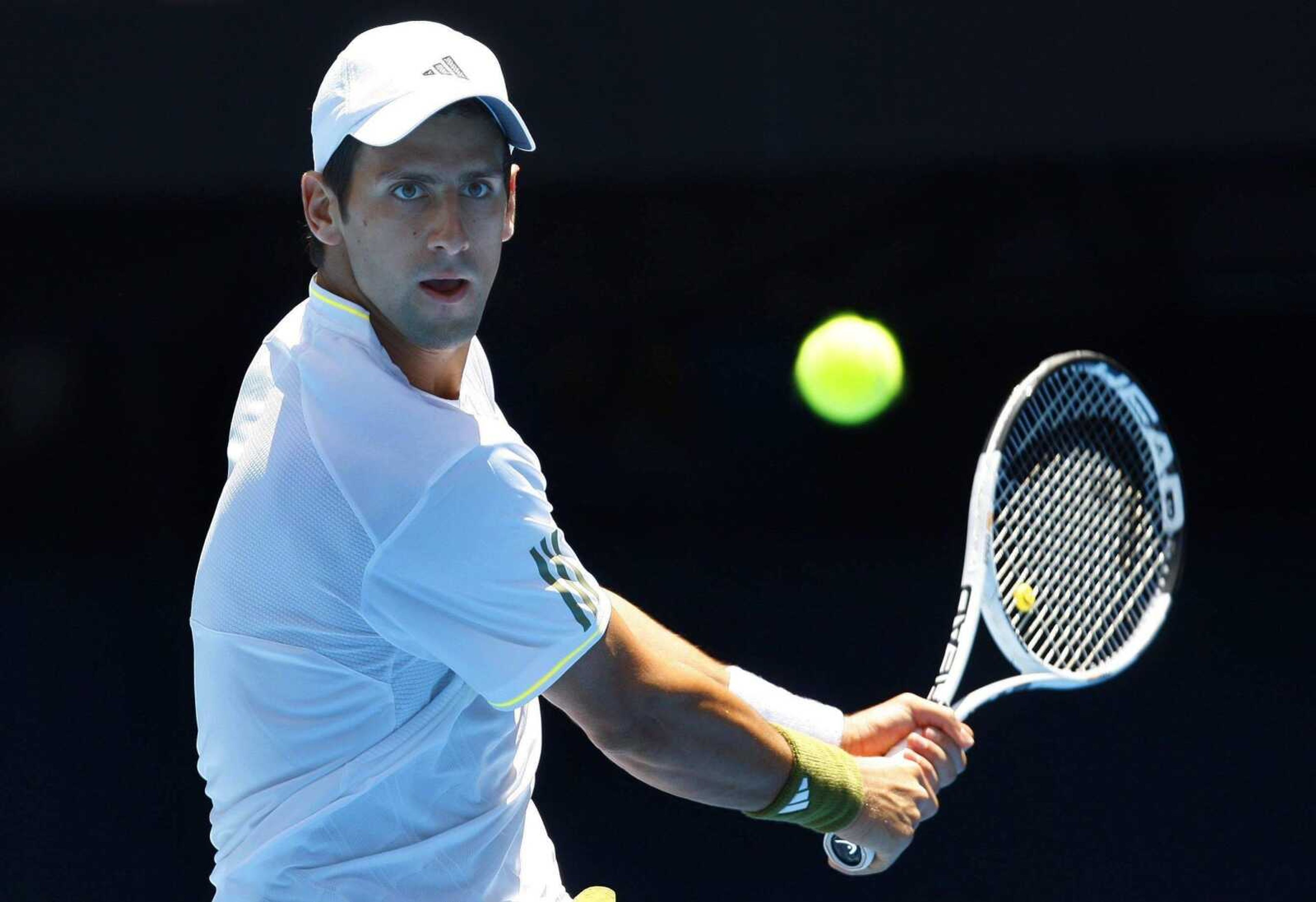 RICK STEVENS ~Associated Press<br>Defending champion Novak Djokovic returns a shot to Jeremy Chardy during their match earlier today at the Australian Open in Melbourne, Australia. Djokovic won in straight sets.