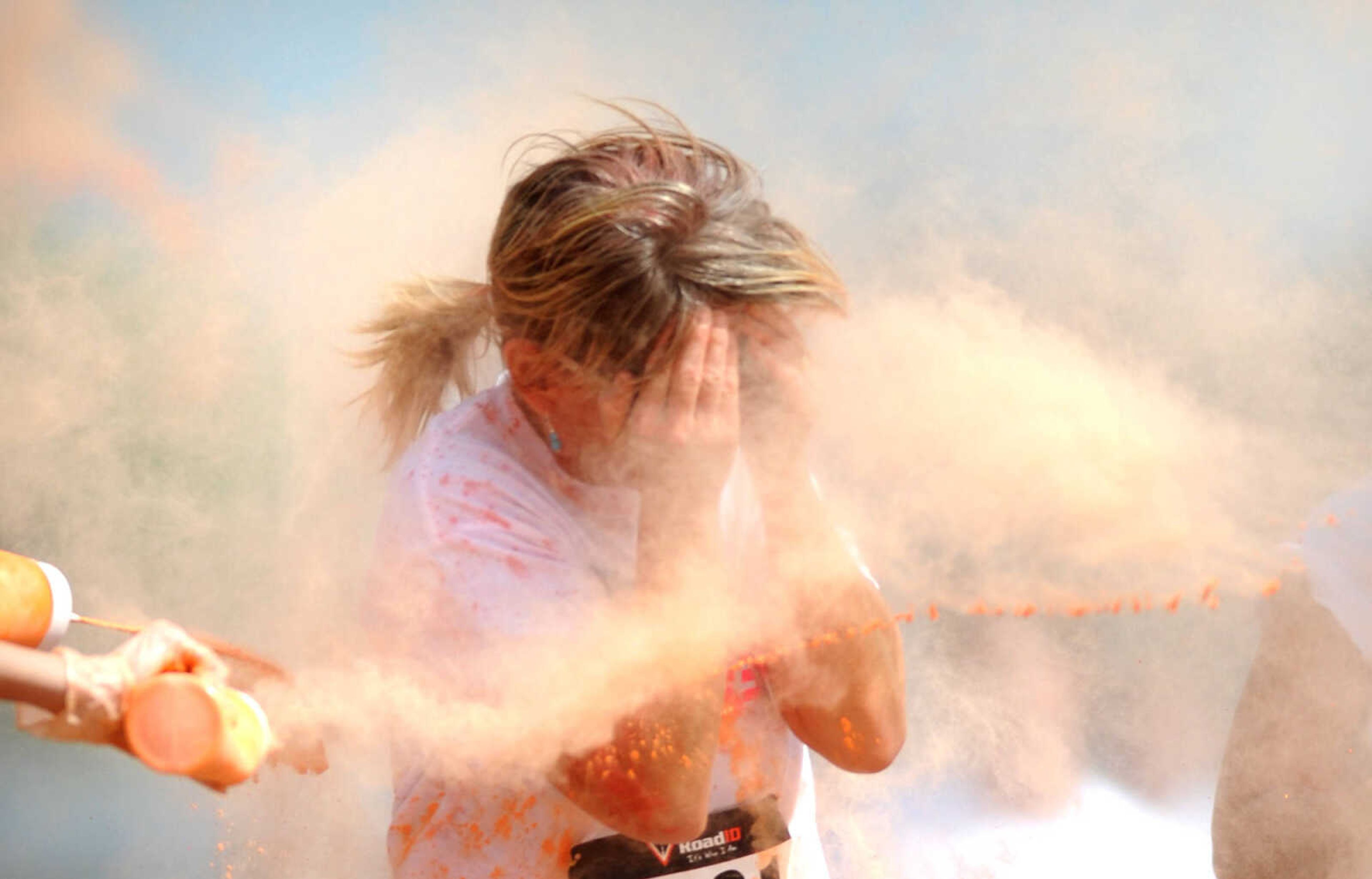 LAURA SIMON ~ lsimon@semissourian.com

Participants in the Color Me Cape 5K are sprayed with orange powder at the first color station on Good Hope Street, Saturday, April 12, 2014, in Cape Girardeau.