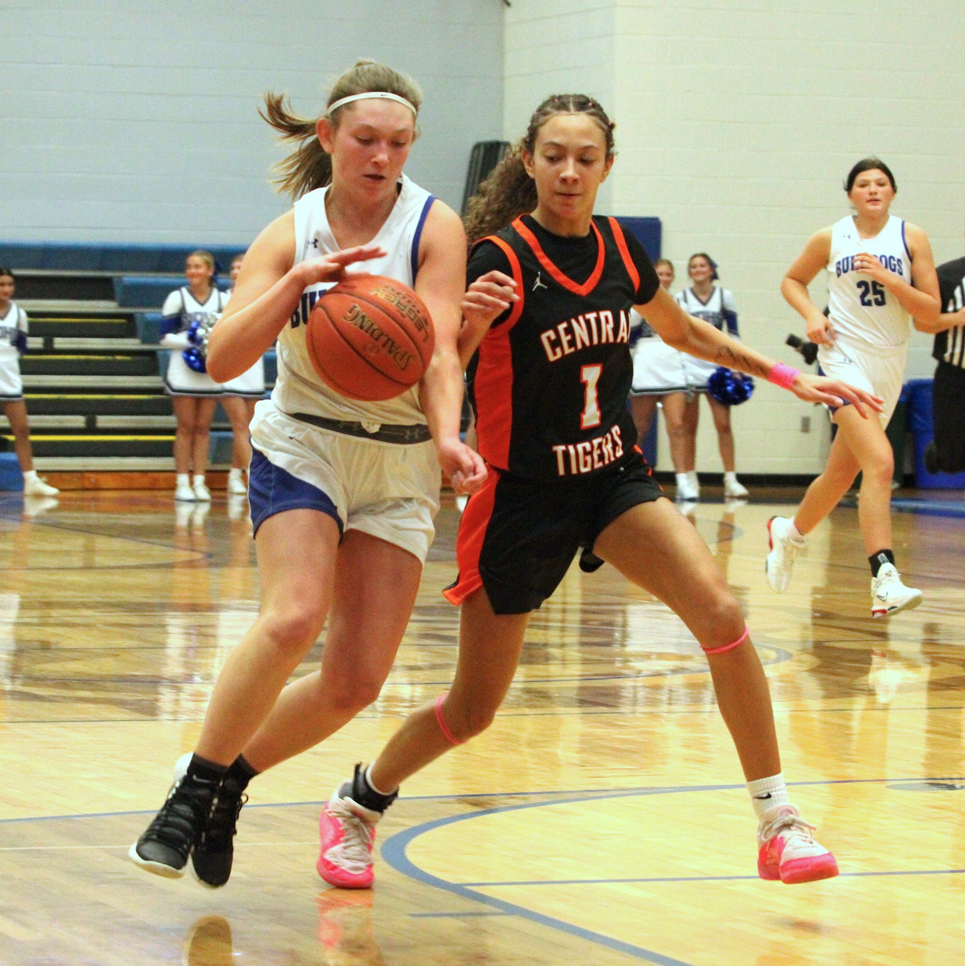 Notre Dame's Skylar Craft (left) and Cape Central's Brooklynn Moss (right) fight for the ball during the December 2 game between the Bulldogs and Tigers.