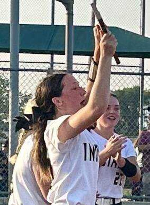 Kennett Lady Indian Kaydee Taylor lofts the C2D1 title plaque for spectators and her team Tuesday at Malden.