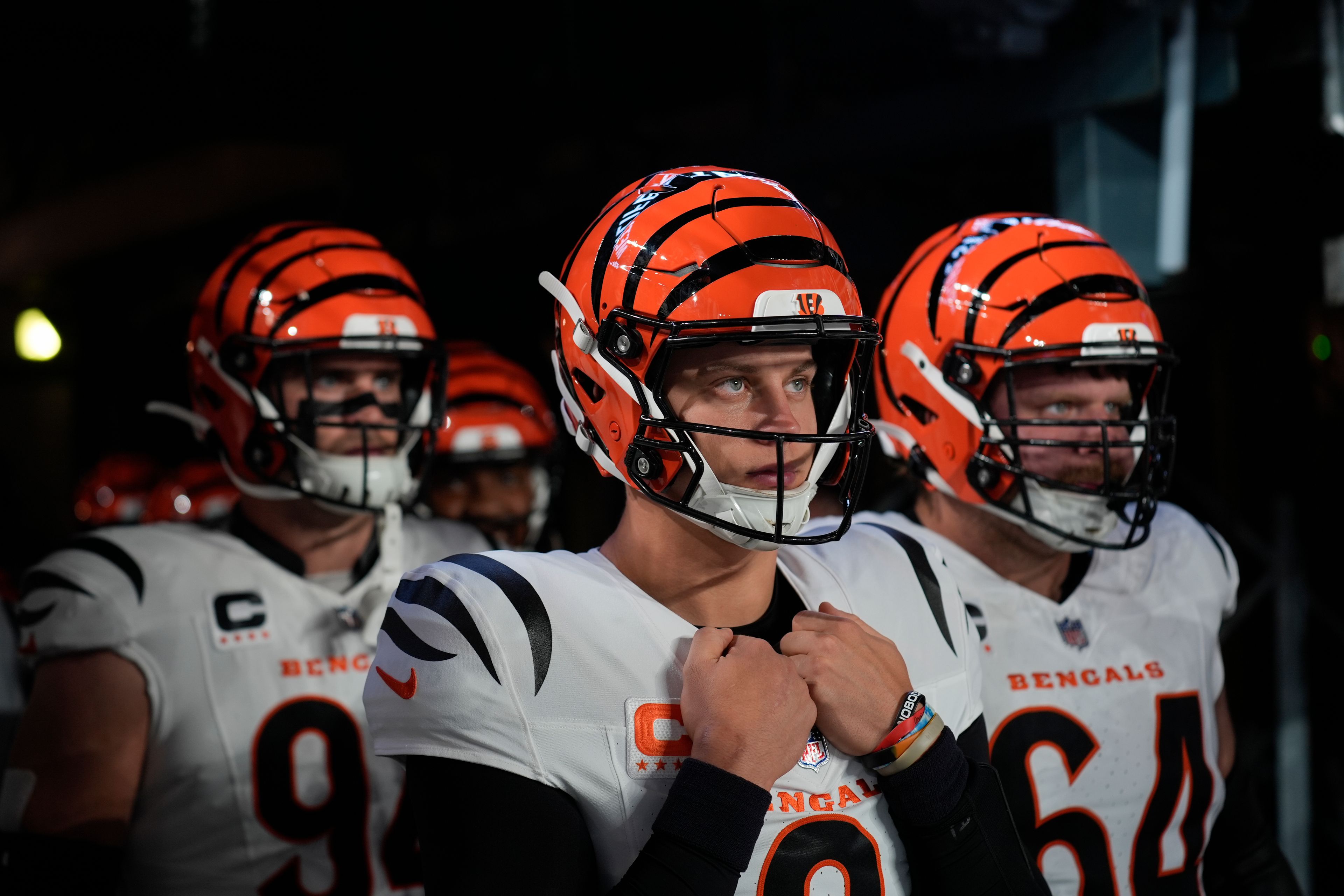 Cincinnati Bengals quarterback Joe Burrow, center, looks out from the tunnel before taking the field with teammates for an NFL football game against the New York Giants, Sunday, Oct. 13, 2024, in East Rutherford, N.J. (AP Photo/Seth Wenig)