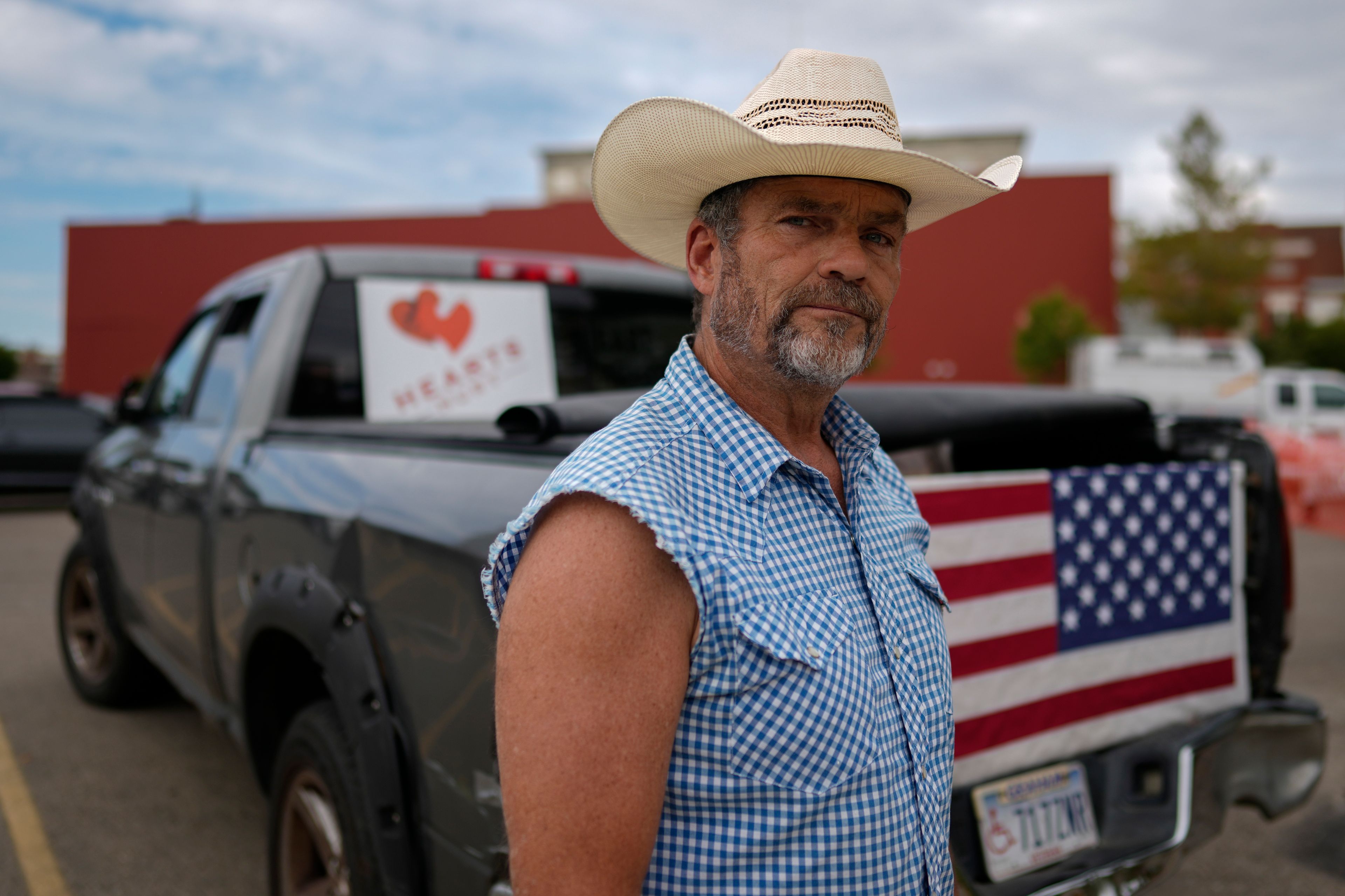 Cowboy David Graham, of Newark, Ohio, on hand with a message of support, stands near his truck across the street from City Hall, Tuesday, Sept. 17, 2024, in Springfield, Ohio. (AP Photo/Carolyn Kaster)