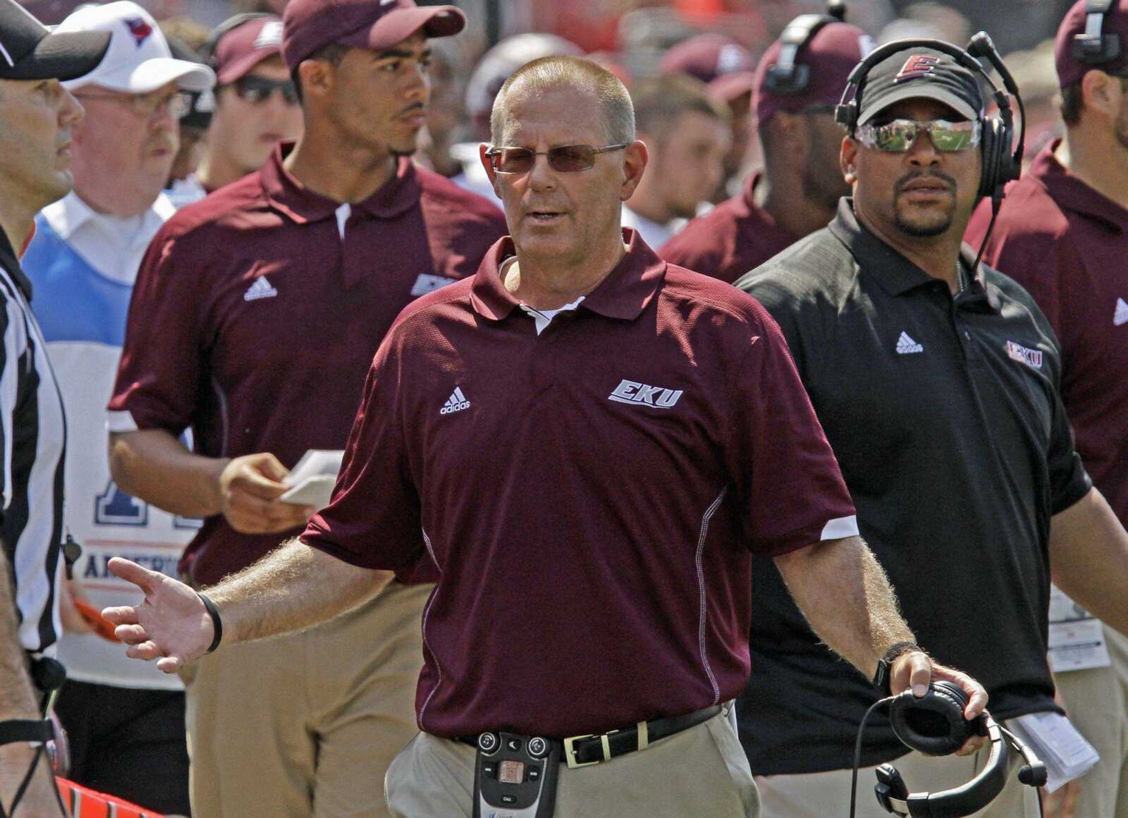 Eastern Kentucky coach Dean Hood, right, questions a penalty against his team in their NCAA college football game against Louisville in Louisville, Ky., Saturday, Sept. 7, 2013. Louisville beat Eastern Kentucky 44-7. (AP Photo/Garry Jones)