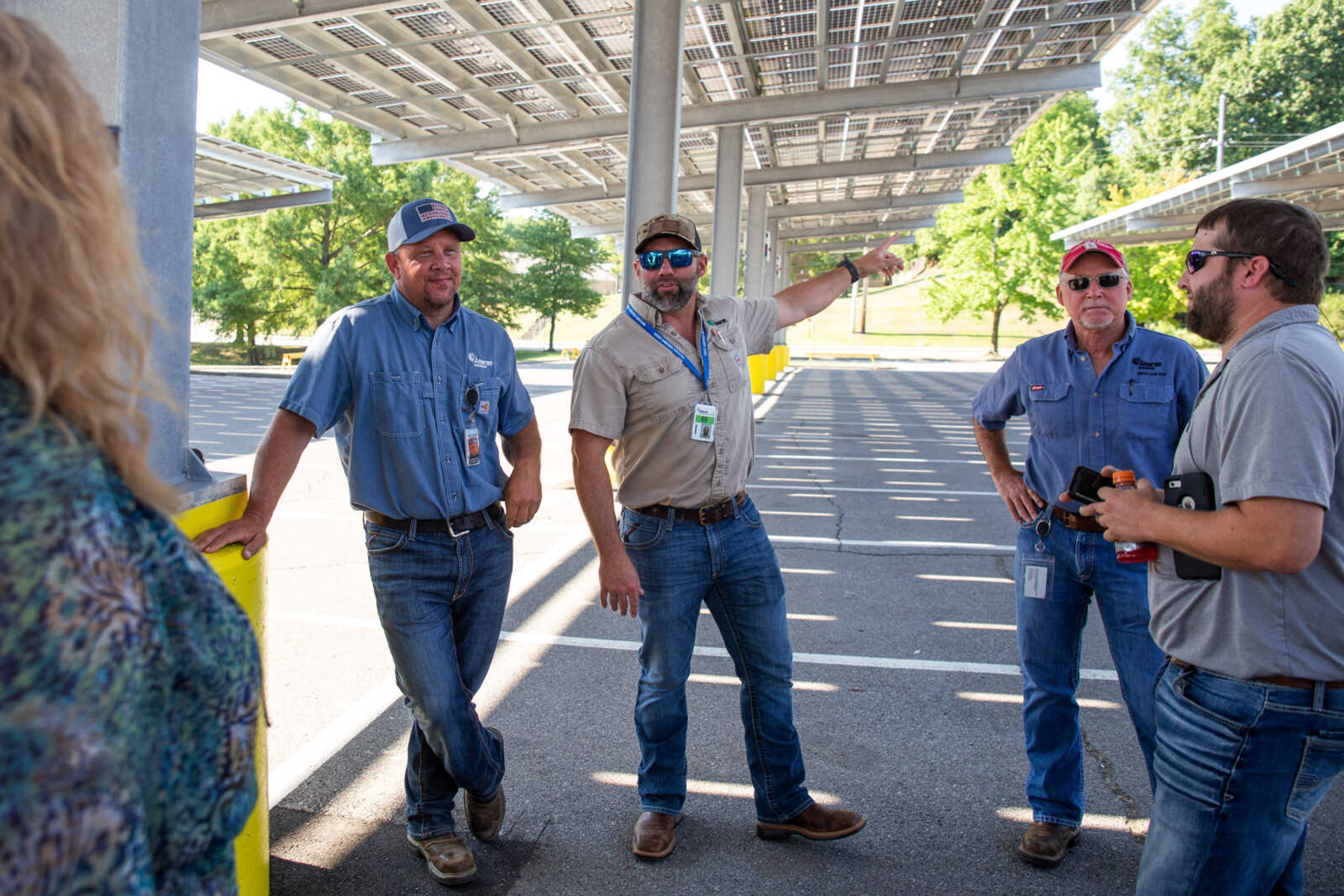 Ameren supervisors, from left, David McKay, Jerad Spain, Brad Hiett and Cory Roper talk with Southeast Missouri State University STEM Deam Dr. Tammy Randolph about logistics of constructing the 3,500 solar panels covering the parking lots in front of the Show Me Center on Thursday, Aug. 25.